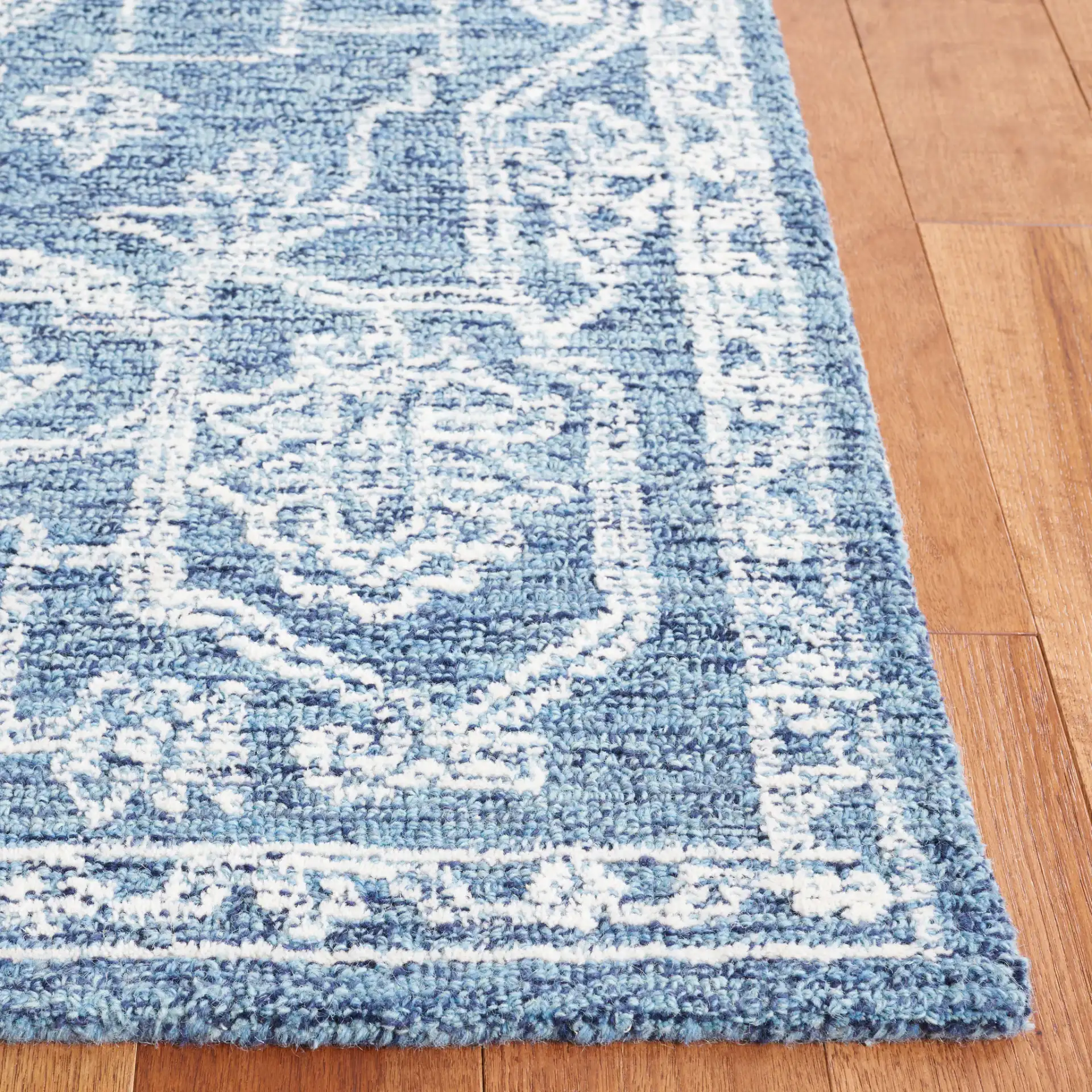 Micro-Loop Diamond Medallion Wool Rug in Blue / Ivory in a styled room