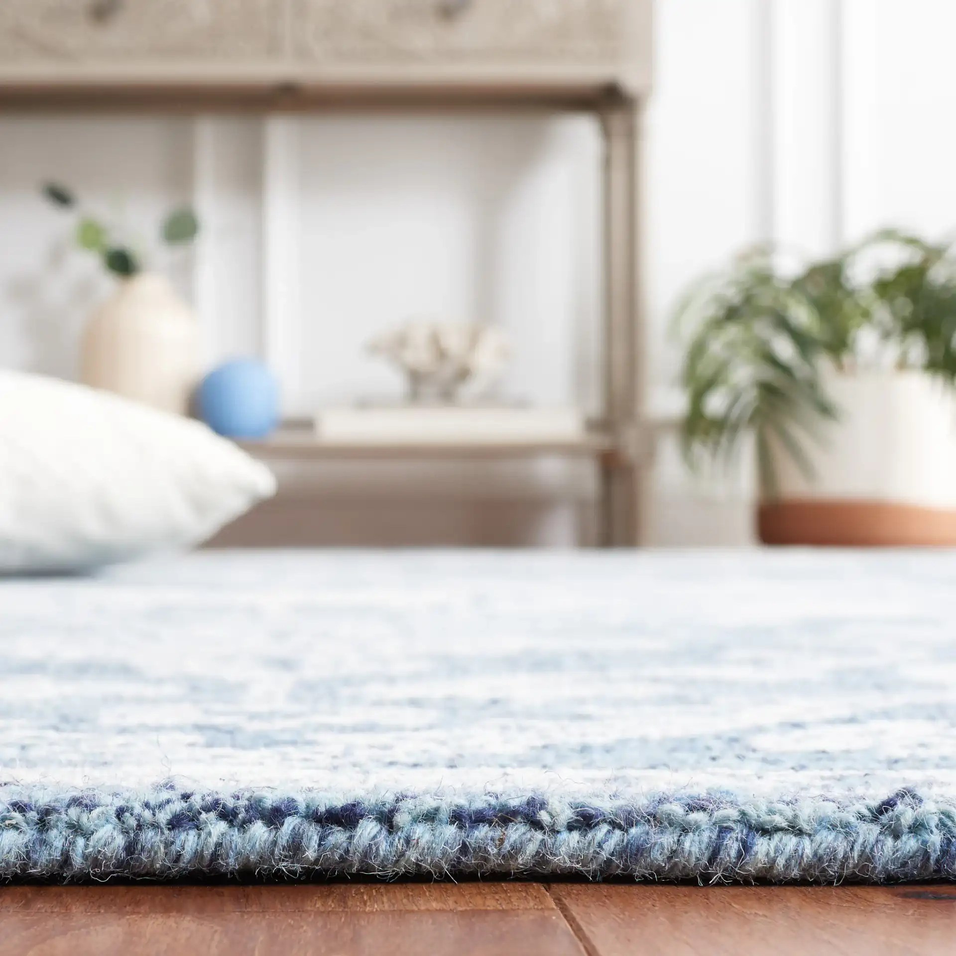 Micro-Loop Diamond Medallion Wool Rug in Blue / Ivory in a styled room