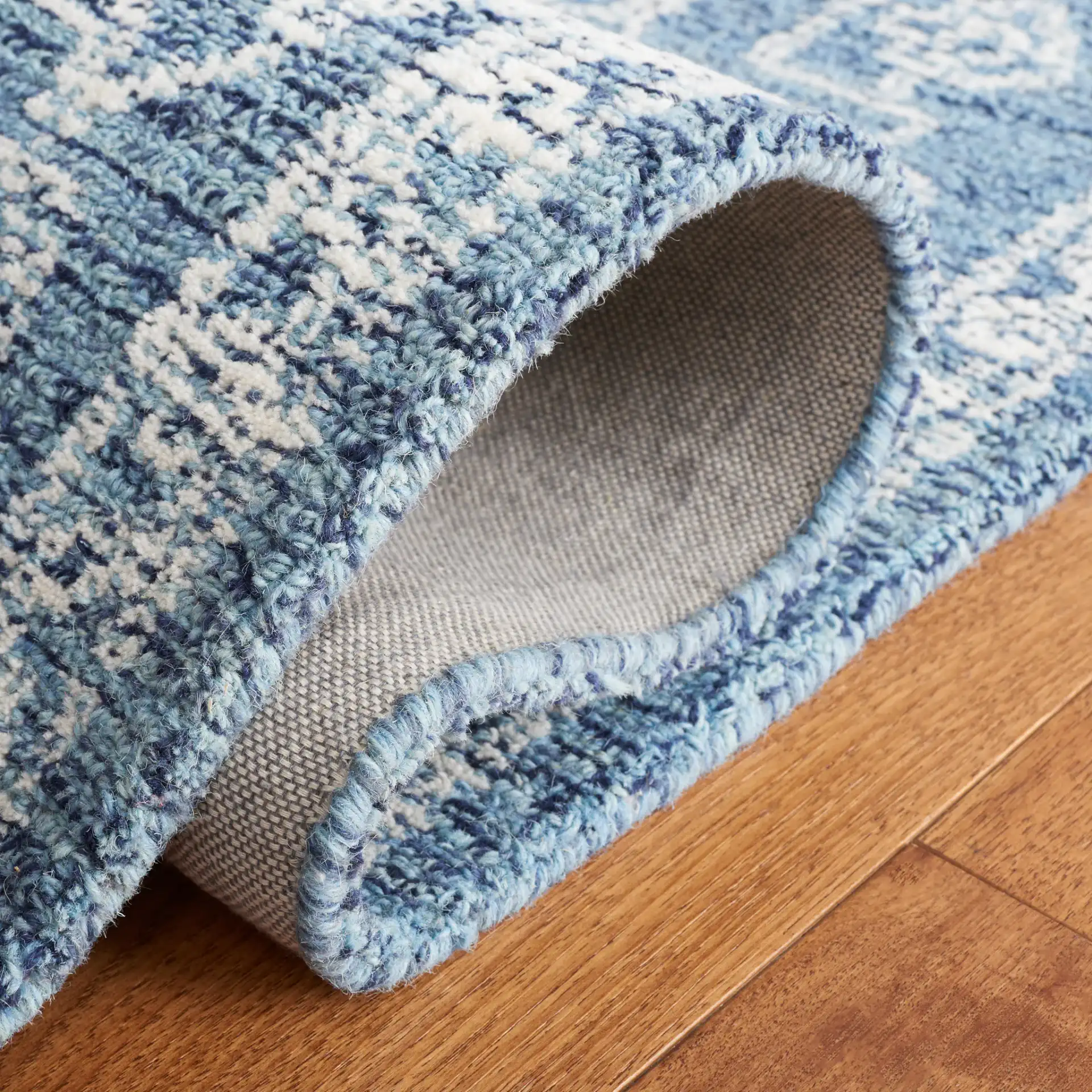 Micro-Loop Diamond Medallion Wool Rug in Blue / Ivory in a styled room