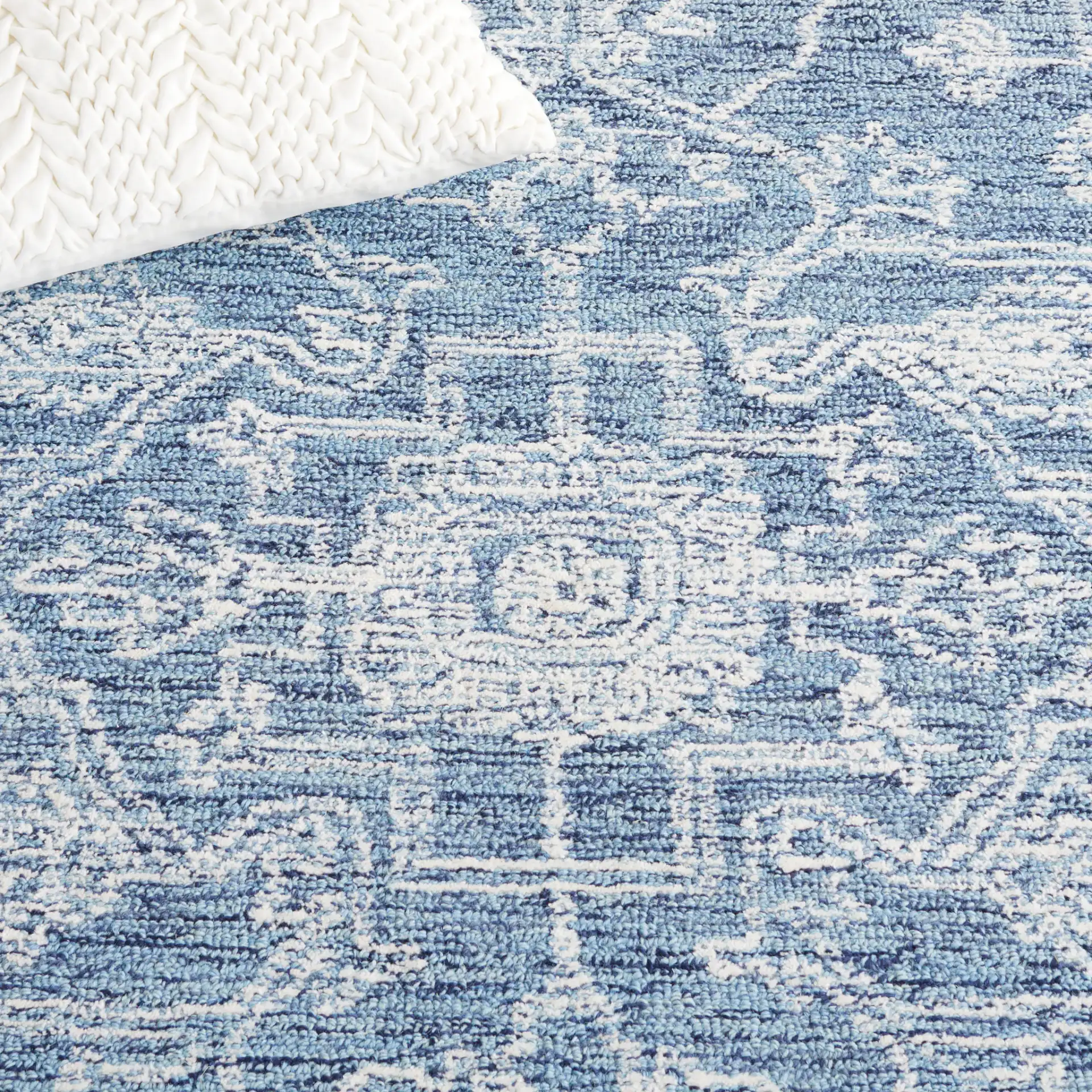 Micro-Loop Diamond Medallion Wool Rug in Blue / Ivory in a styled room