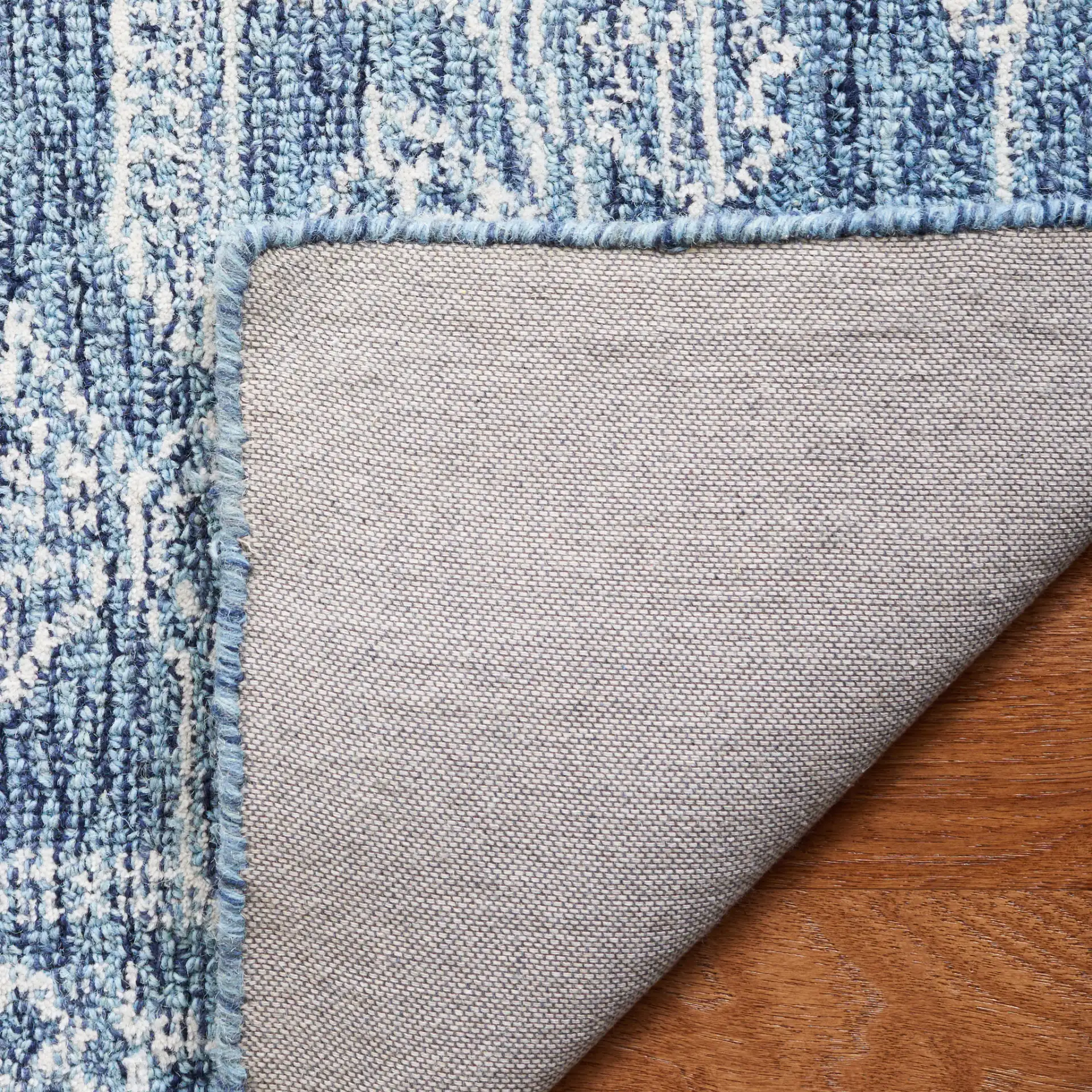 Micro-Loop Diamond Medallion Wool Rug in Blue / Ivory in a styled room