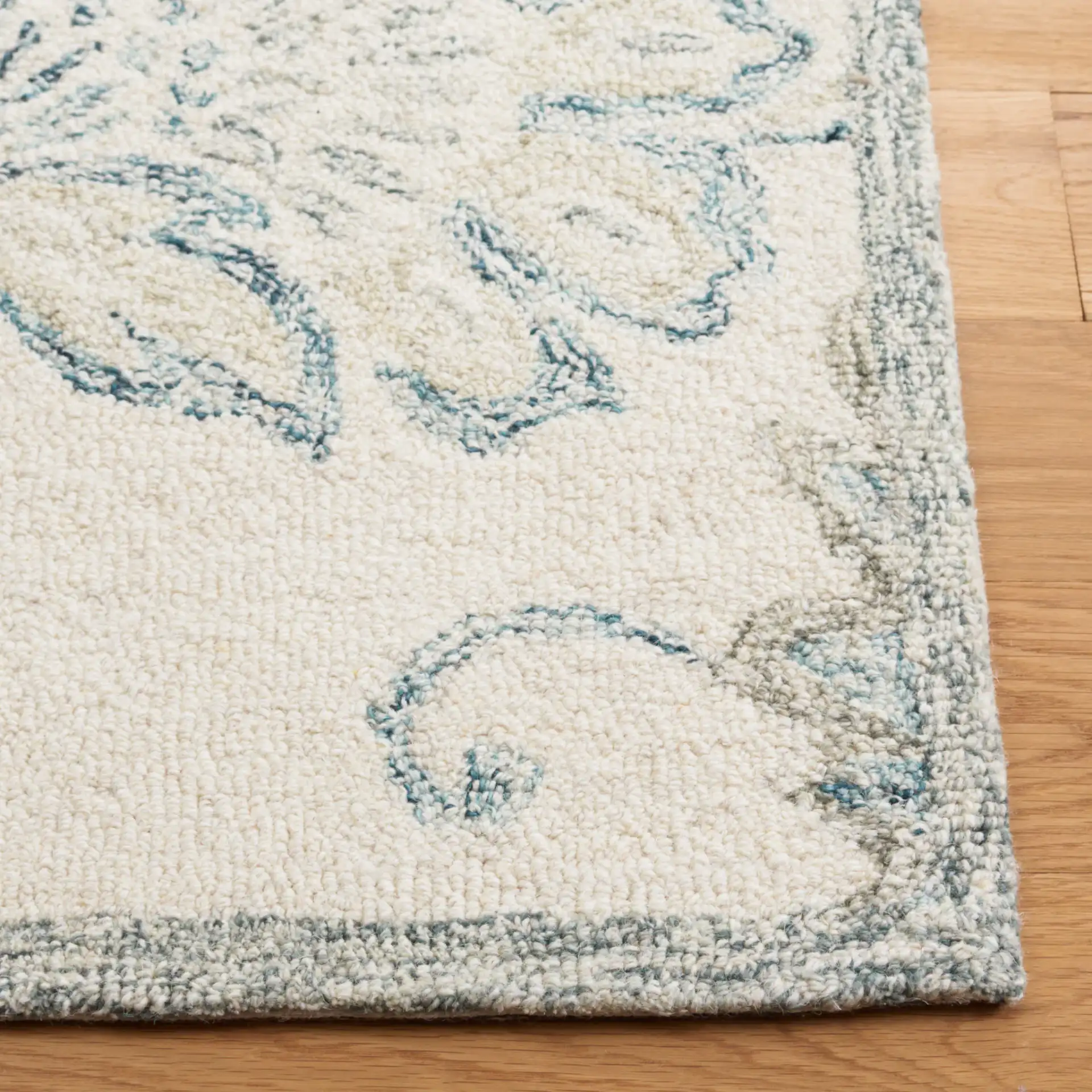 Micro-Loop Floral Hand-Tufted Wool Rug in Ivory / Blue in a styled room
