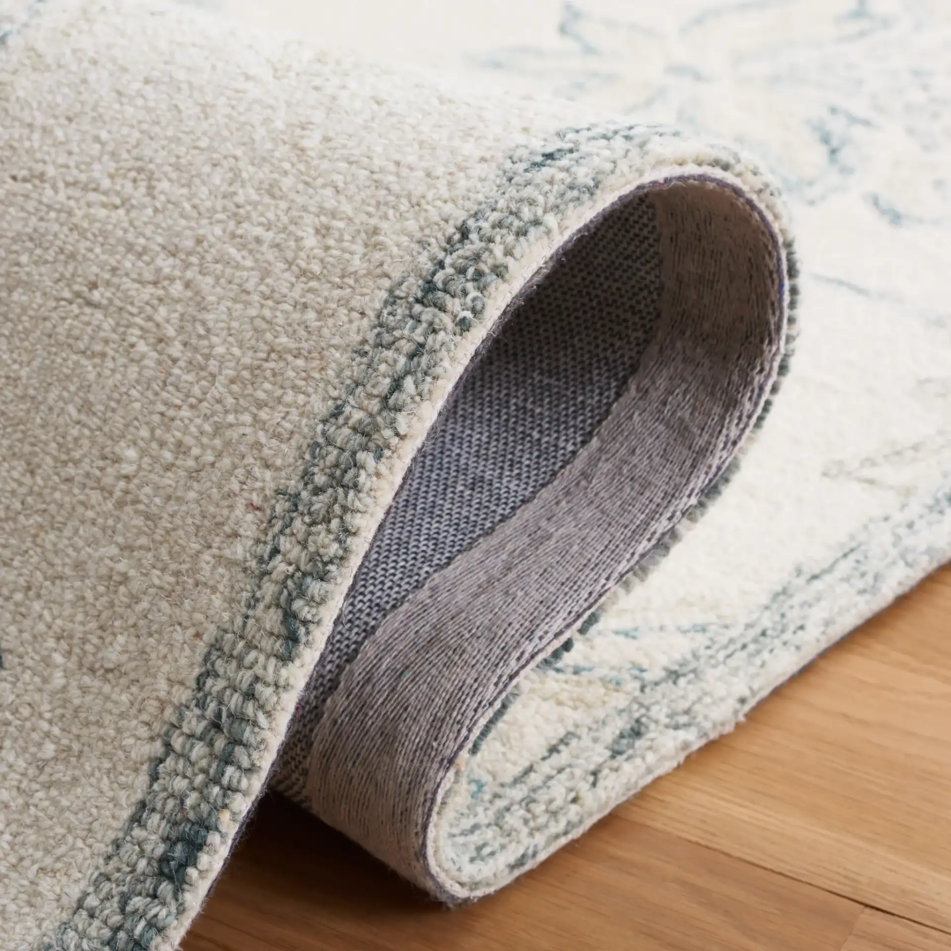 Micro-Loop Floral Hand-Tufted Wool Rug in Ivory / Blue in a styled room