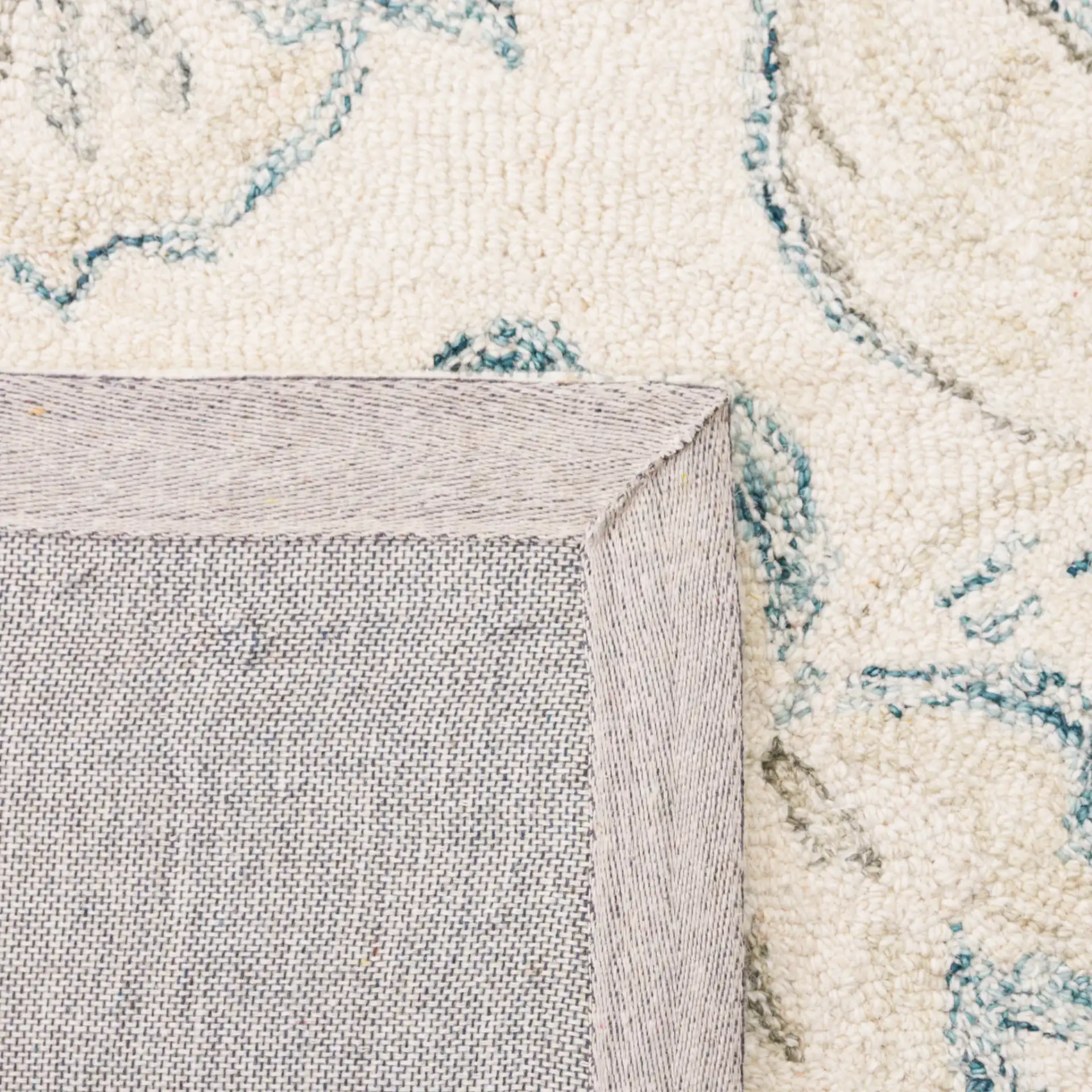 Micro-Loop Floral Hand-Tufted Wool Rug in Ivory / Blue in a styled room
