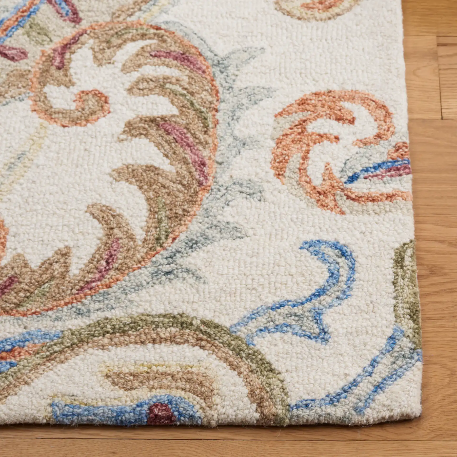 Micro-Loop Paisley Hand-Tufted Wool Rug in Ivory / Rust in a styled room