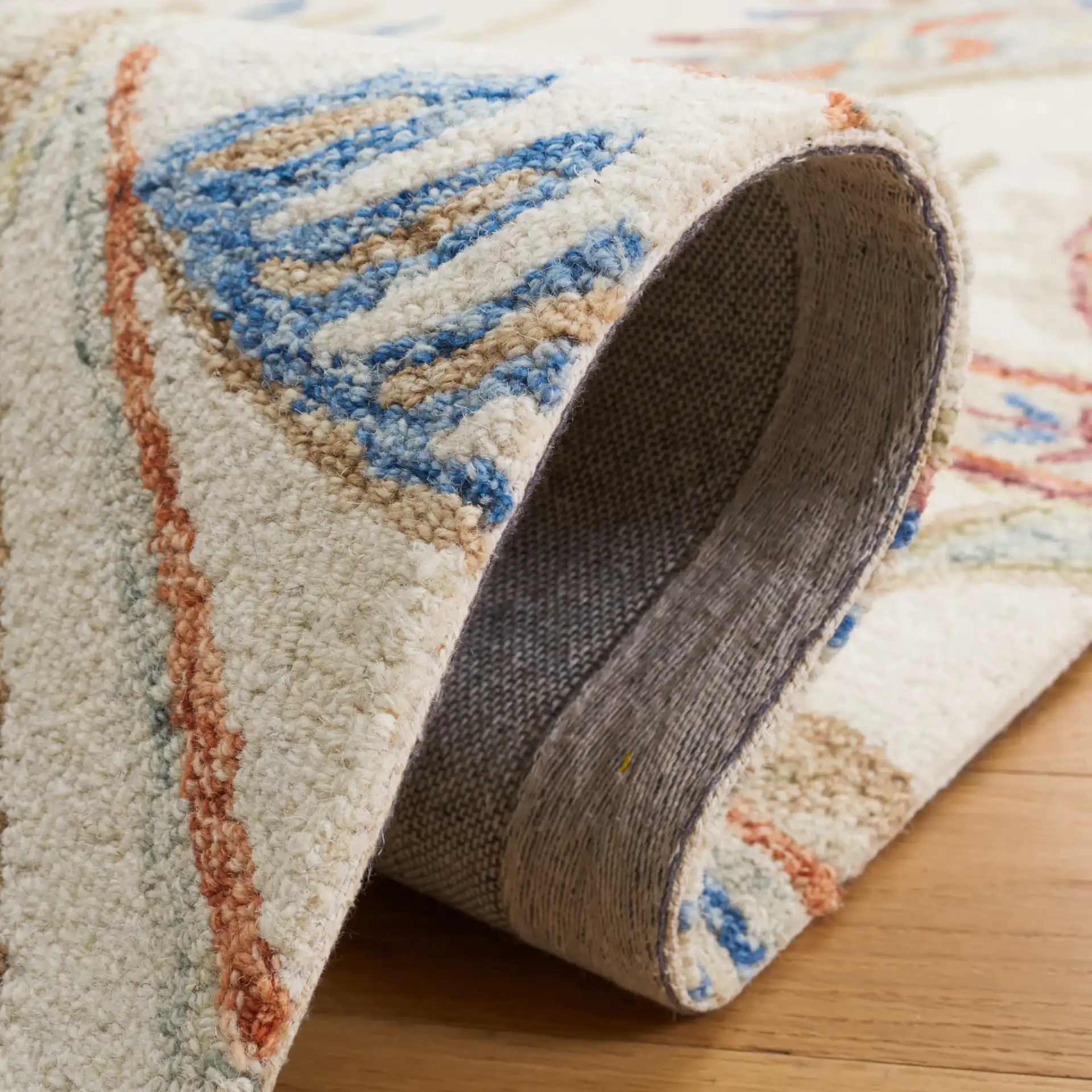 Micro-Loop Paisley Hand-Tufted Wool Rug in Ivory / Rust in a styled room