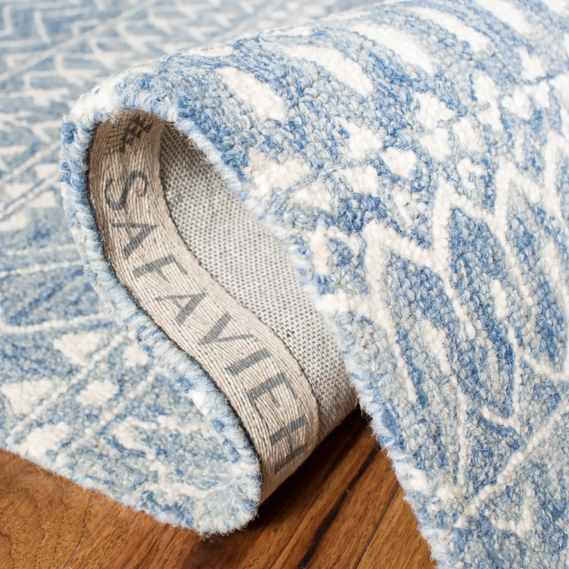 Micro-Loop Micro Loop Banded Geometric Hand-Tufted Wool Rug in Blue / Ivory in a styled room