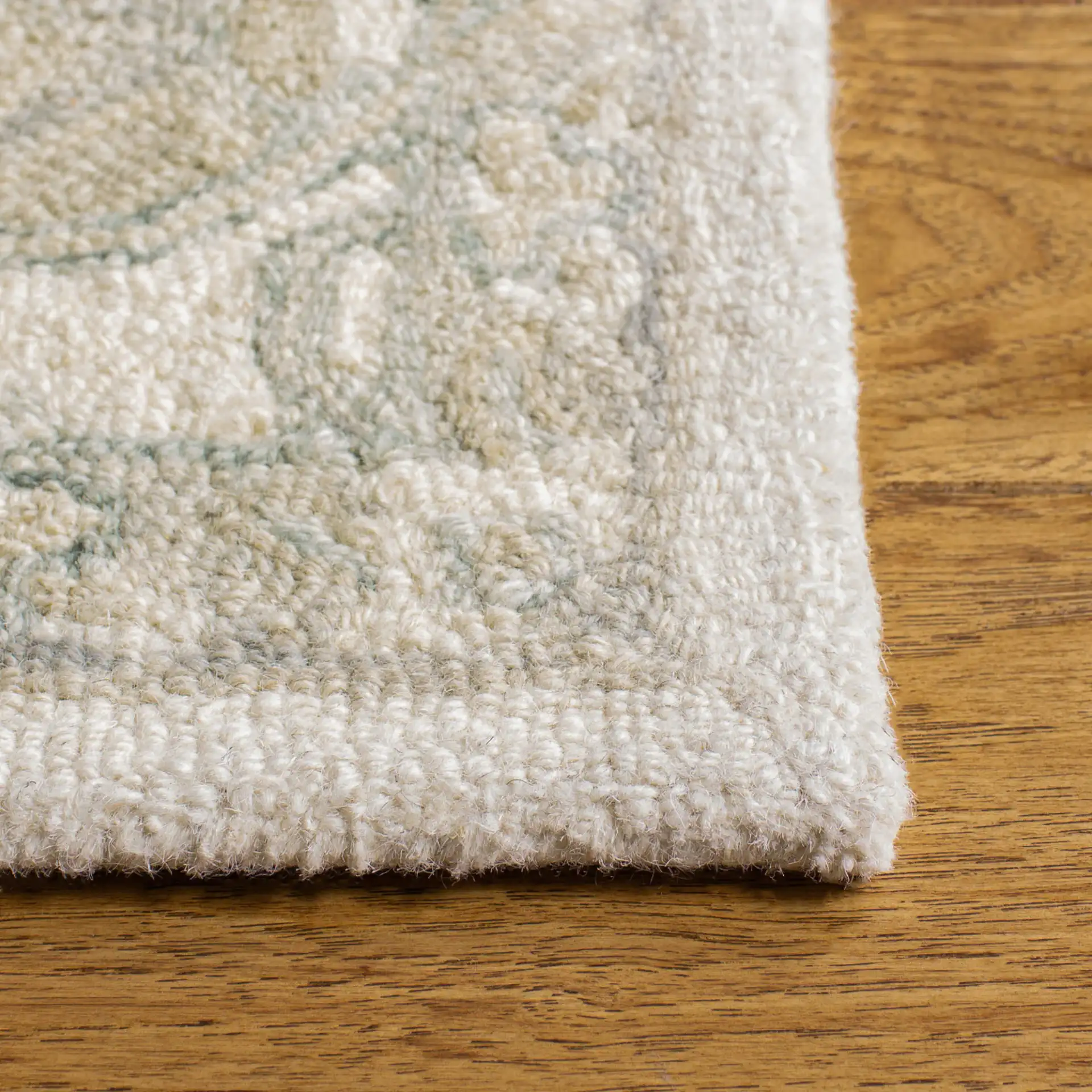 Micro-Loop Micro Loop Stepped Medallion Hand-Tufted Wool Rug in Ivory / Beige in a styled room