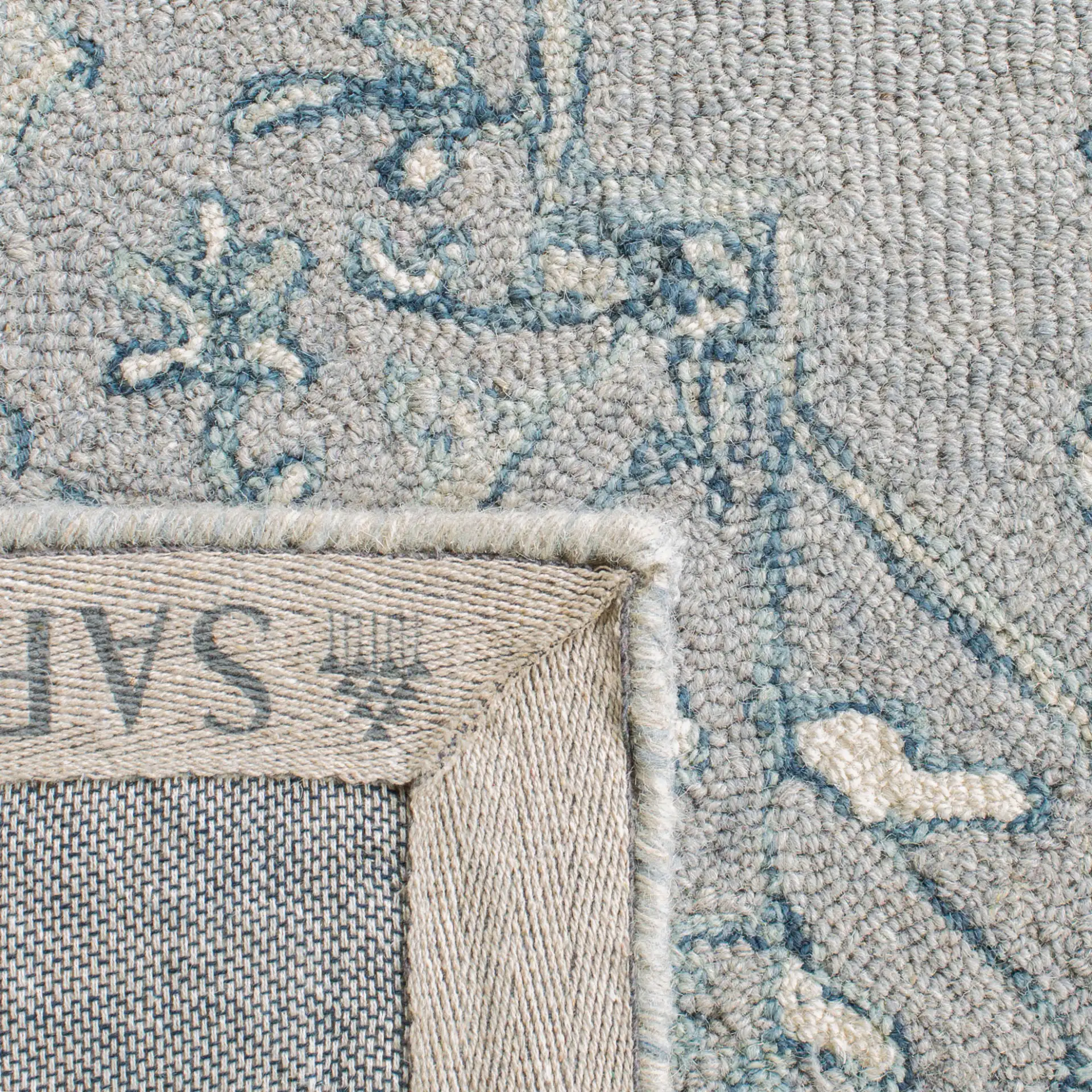 Micro-Loop Micro Loop Floral Medallion Hand-Tufted Wool Rug in Light Gray / Ivory in a styled room