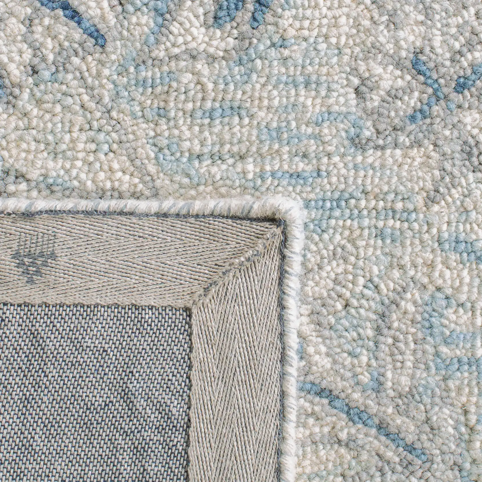 Micro-Loop Micro Loop Scrolling Floral Hand-Tufted Wool Rug in Light Blue / Ivory in a styled room