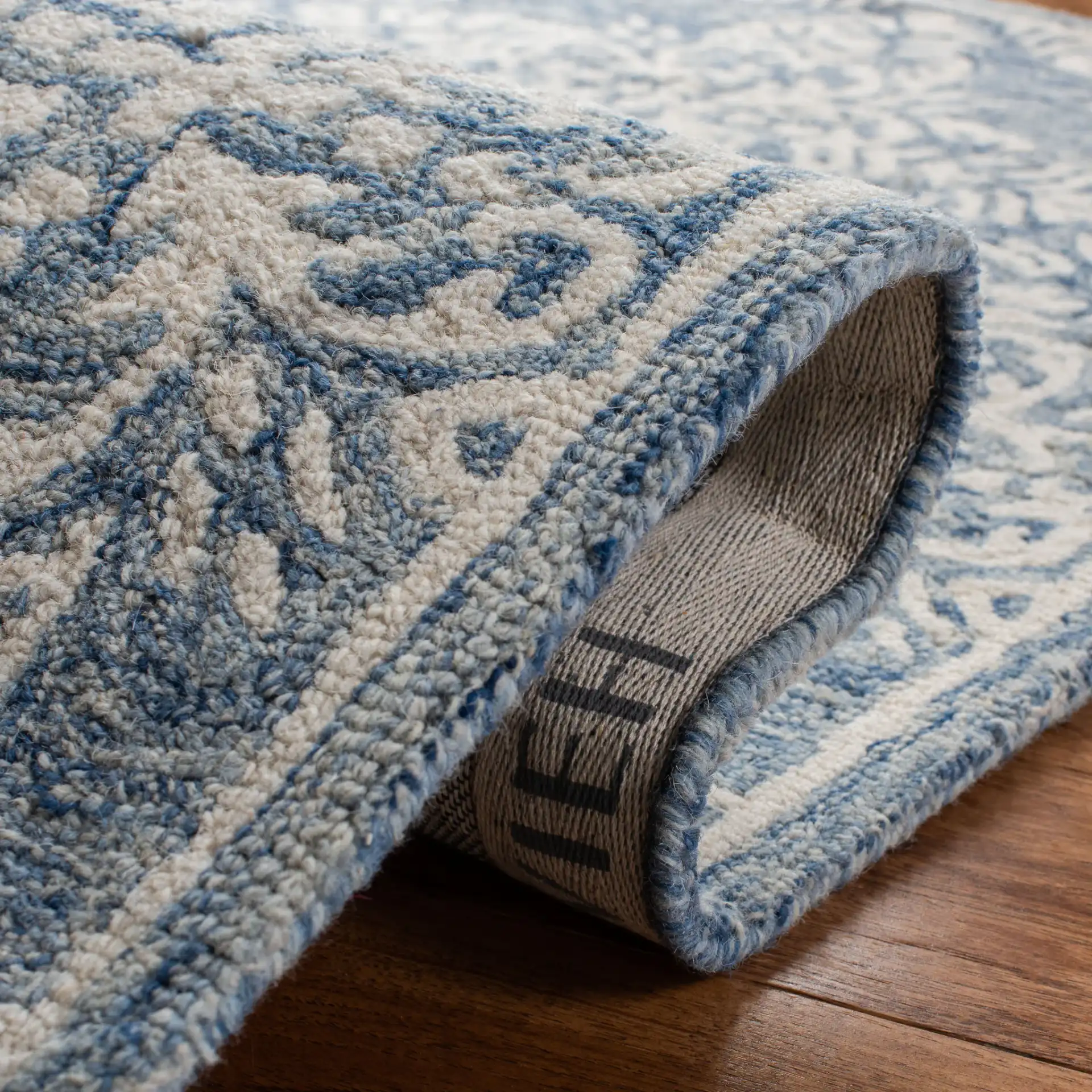 Micro-Loop Damask Tile Hand-Tufted Wool Rug in Blue / Ivory in a styled room