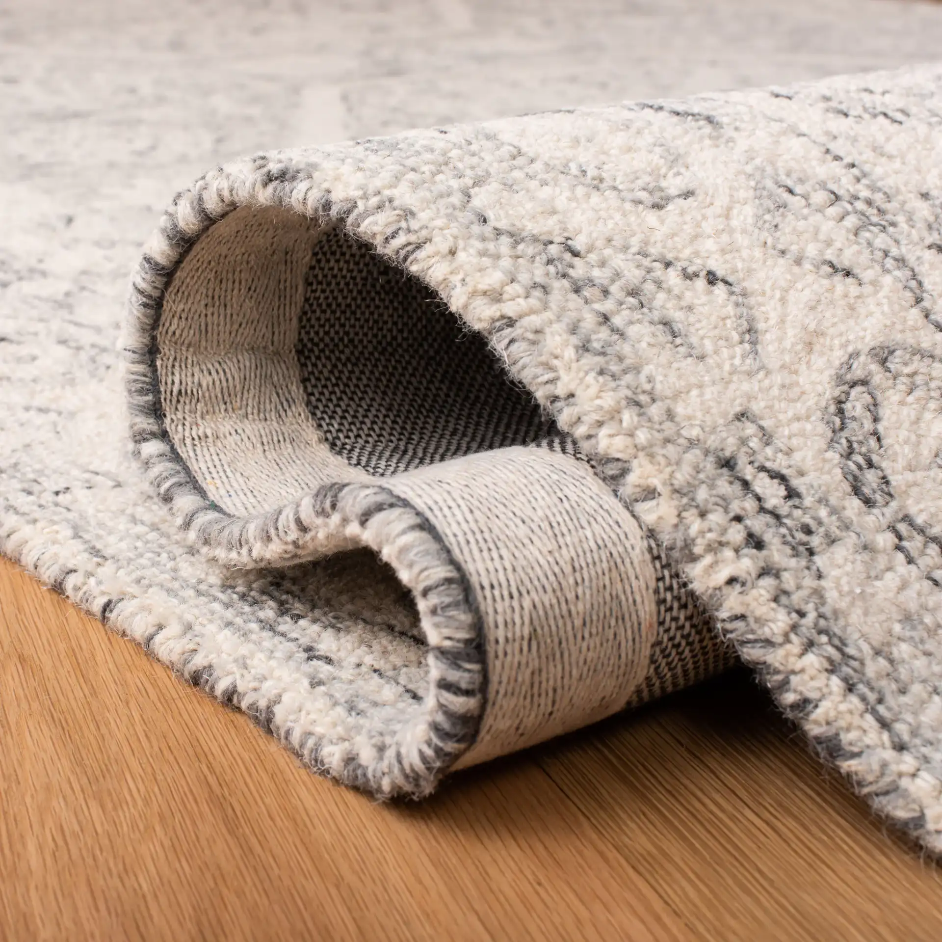 Micro-Loop Medallion Border Hand-Tufted Wool Rug in Charcoal / Ivory in a styled room