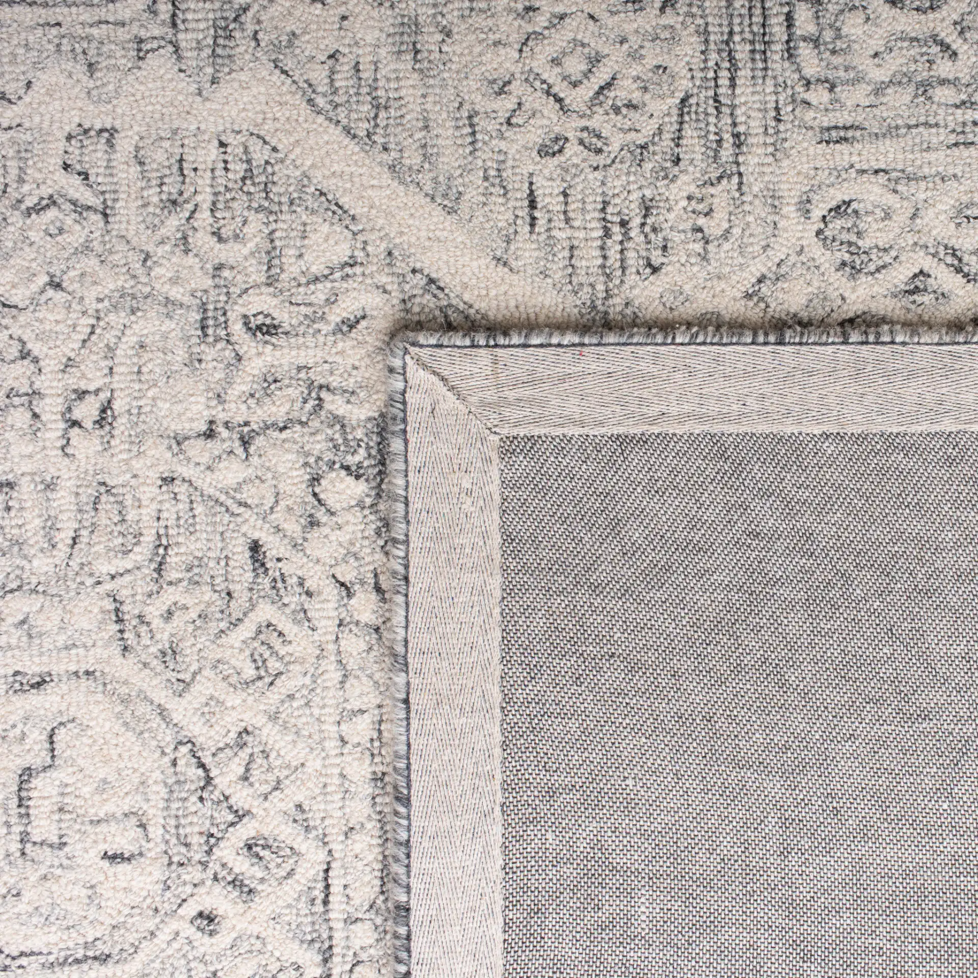 Micro-Loop Medallion Border Hand-Tufted Wool Rug in Charcoal / Ivory in a styled room