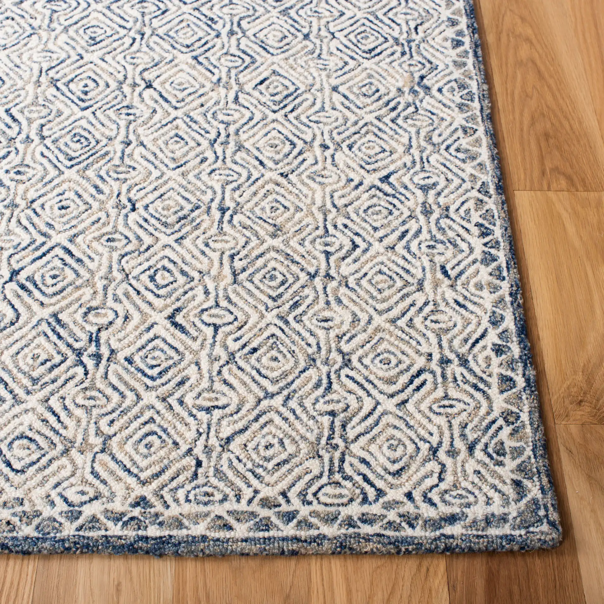 Micro-Loop Diamond Hand-Tufted Wool Rug in Navy / Ivory in a styled room