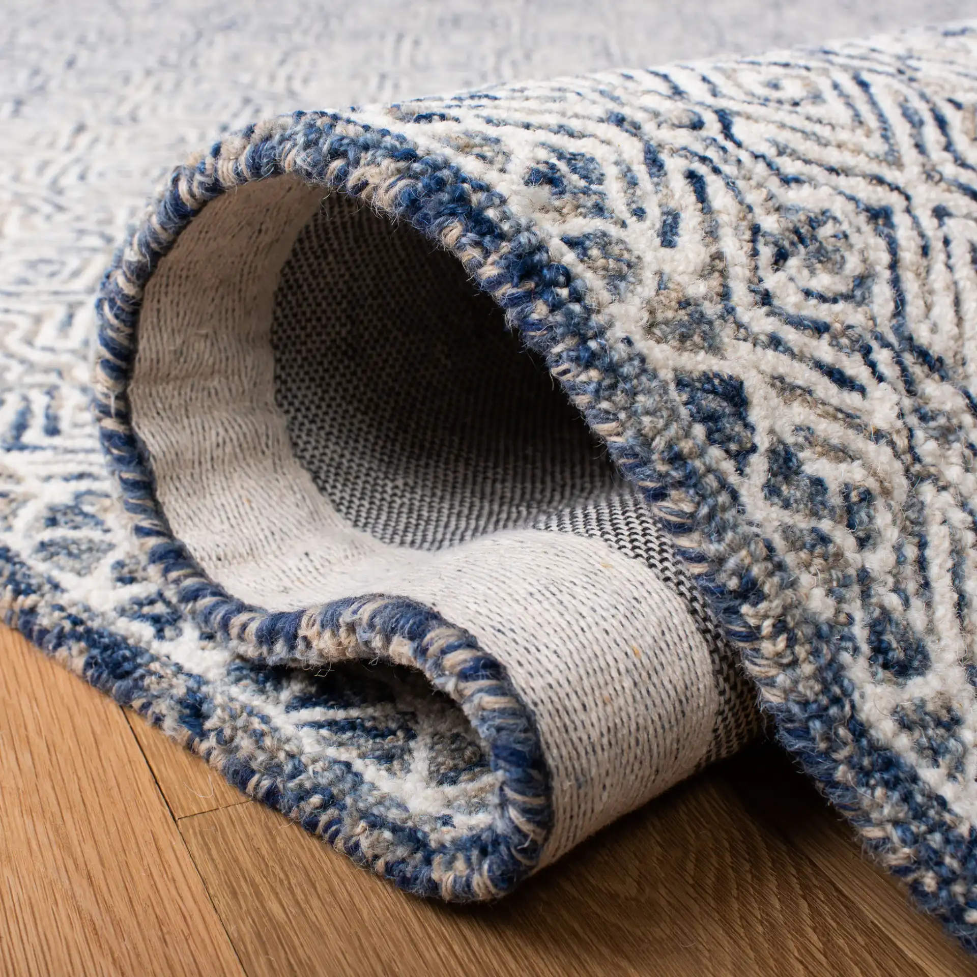 Micro-Loop Diamond Hand-Tufted Wool Rug in Navy / Ivory in a styled room