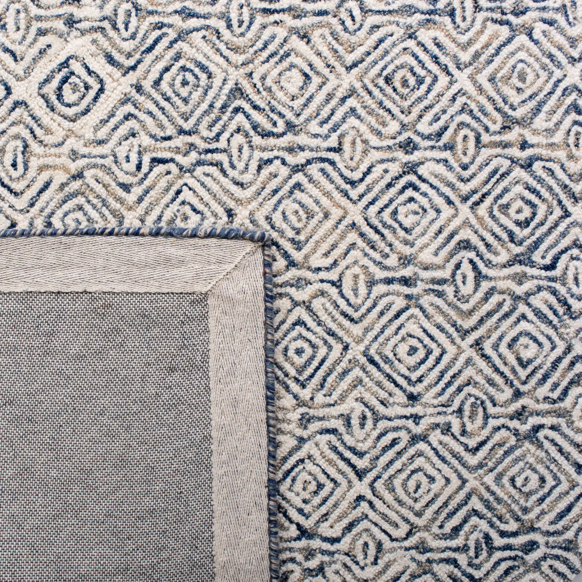 Micro-Loop Diamond Hand-Tufted Wool Rug in Navy / Ivory in a styled room