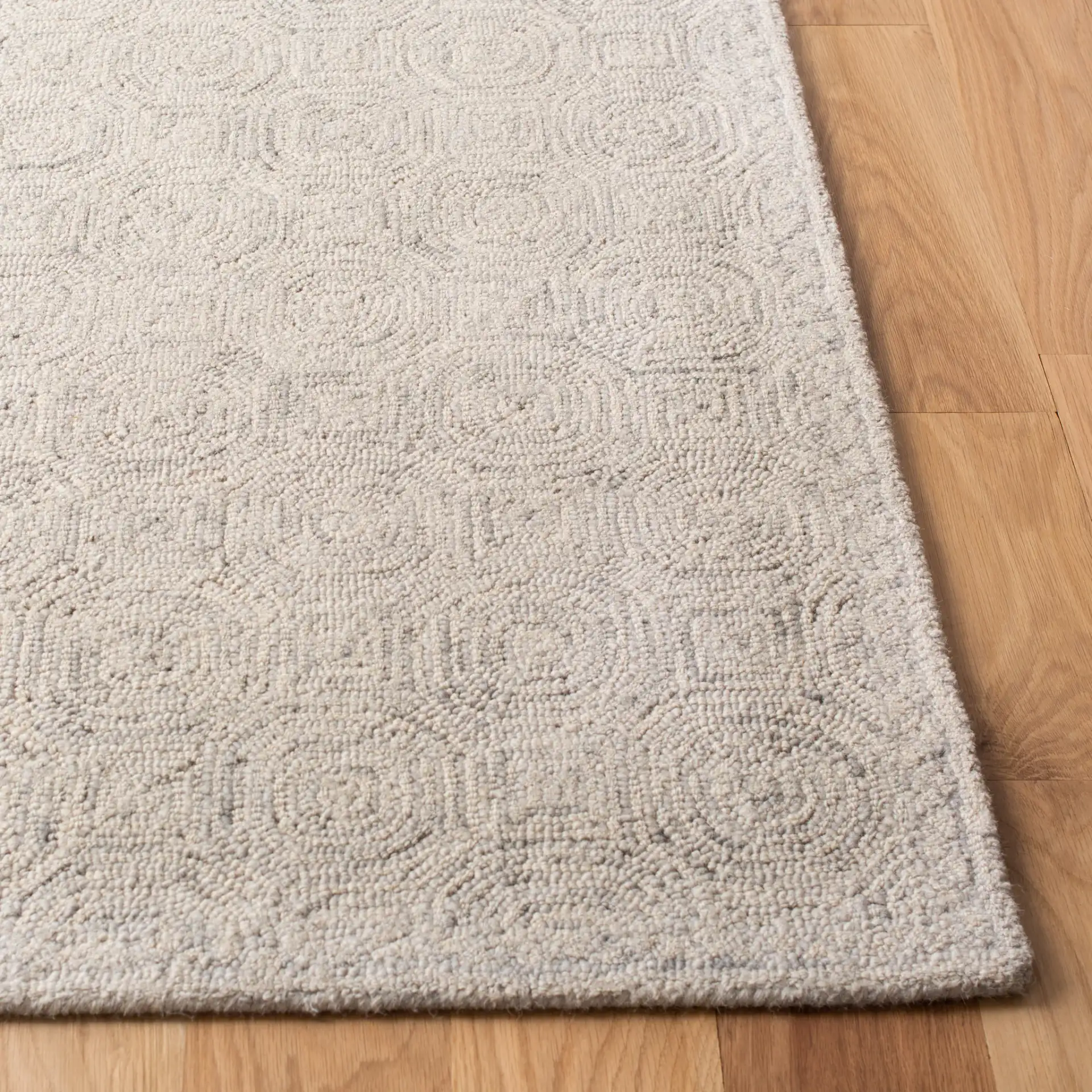 Micro-Loop Concentric Square Hand-Tufted Wool Rug in Silver / Gray in a styled room