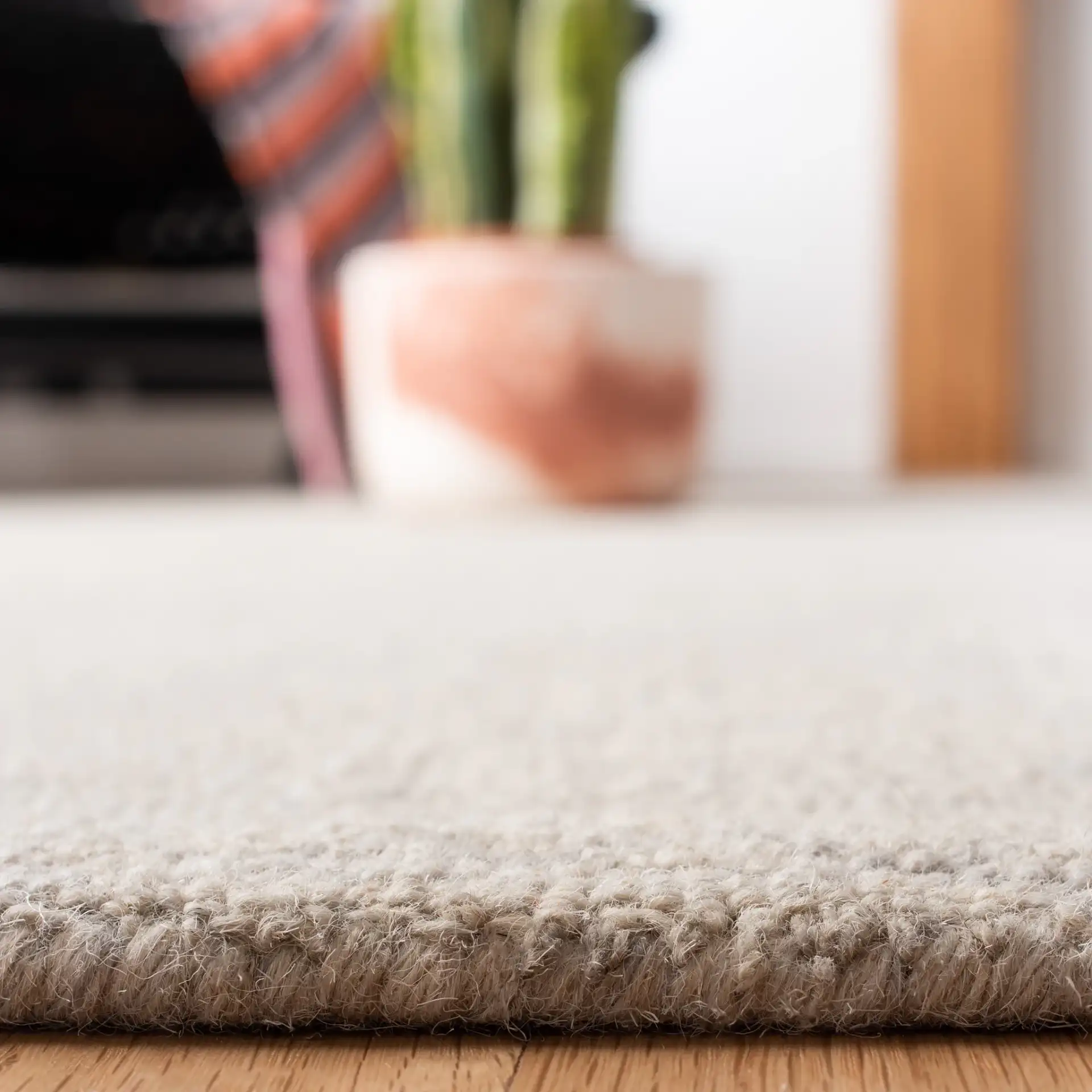 Micro-Loop Concentric Square Hand-Tufted Wool Rug in Silver / Gray in a styled room