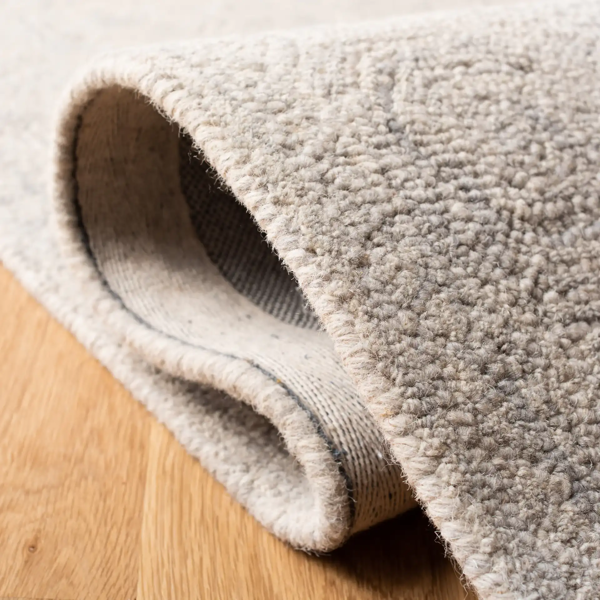 Micro-Loop Concentric Square Hand-Tufted Wool Rug in Silver / Gray in a styled room