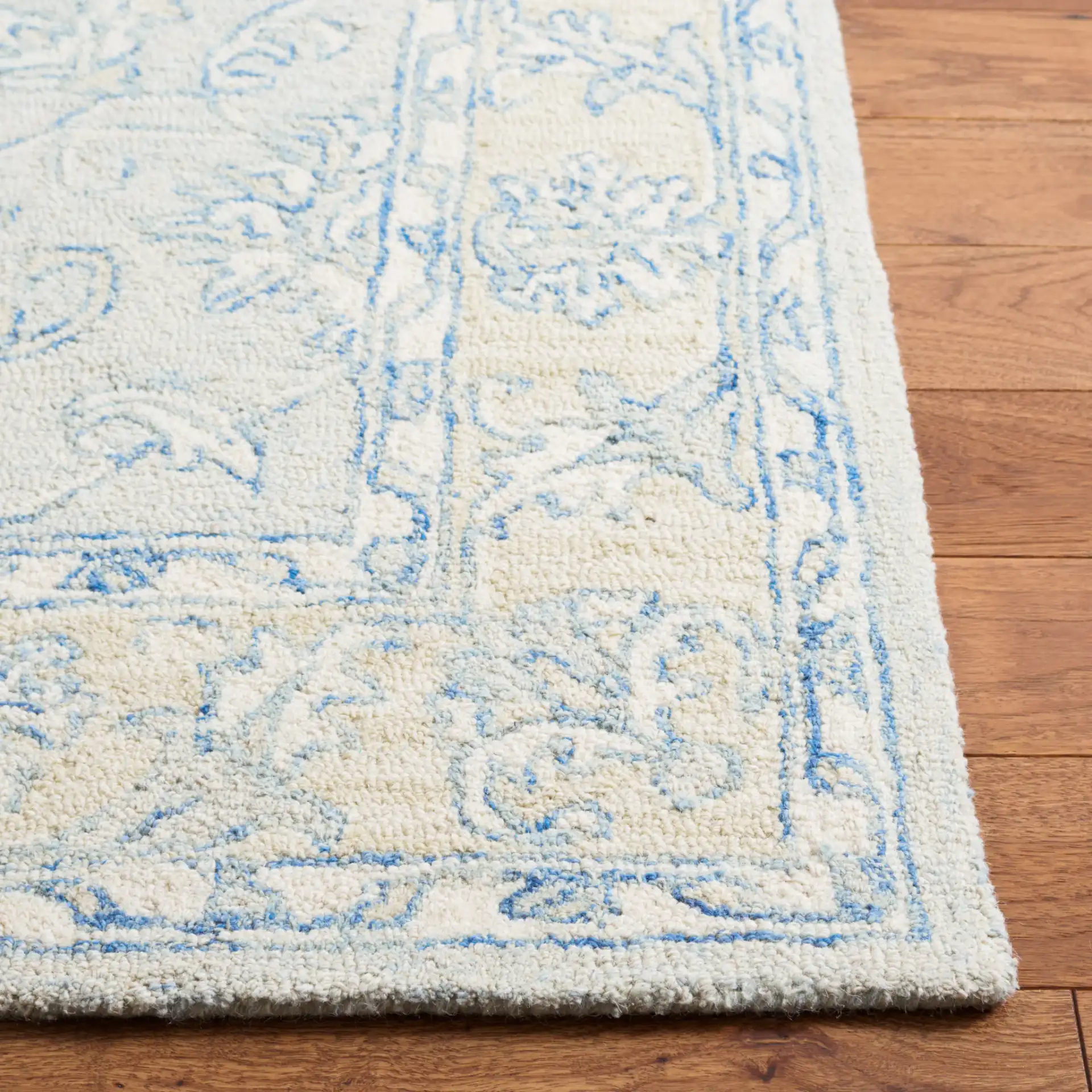 Micro-Loop Floral Border Hand-Tufted Wool Rug in Blue / Beige in a styled room