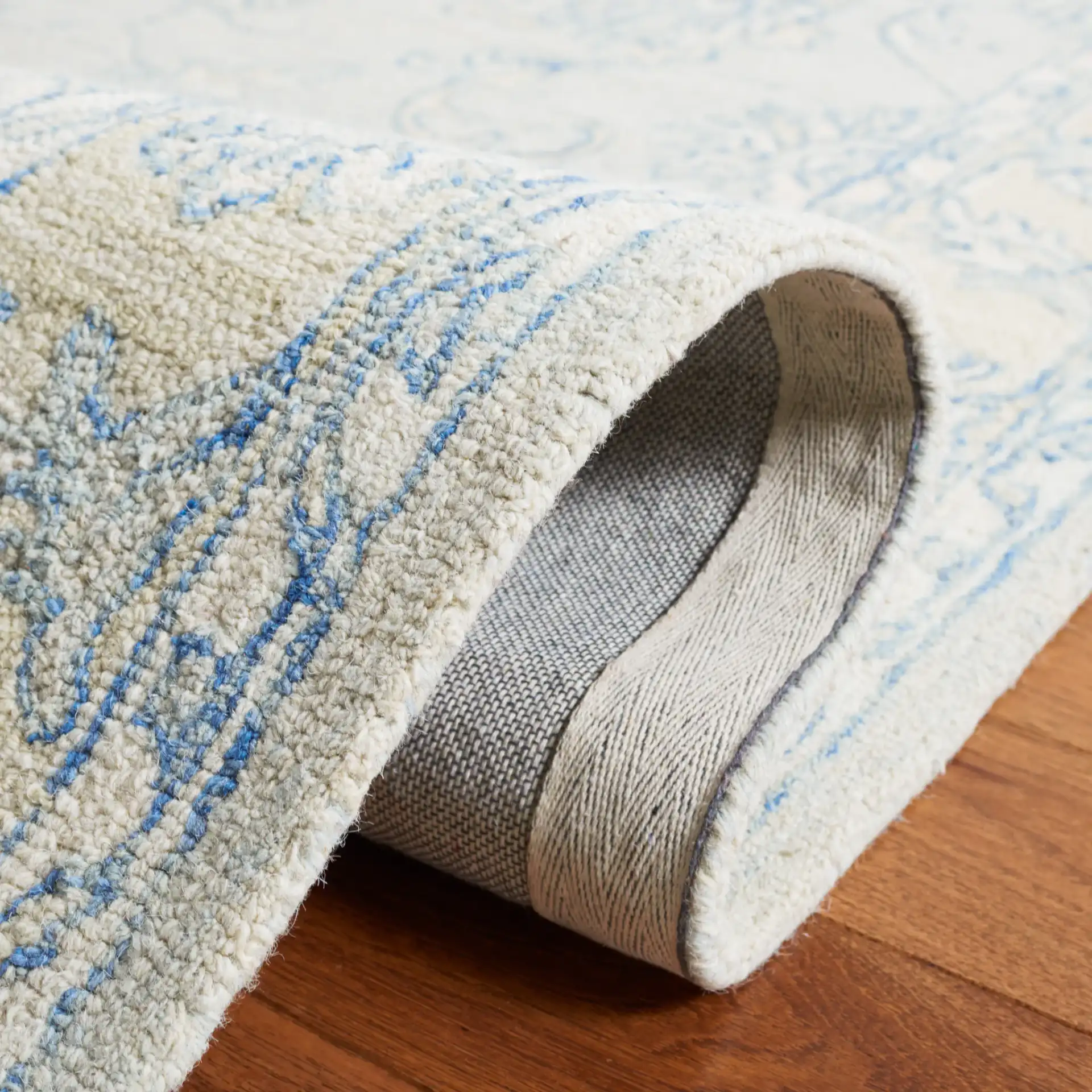Micro-Loop Floral Border Hand-Tufted Wool Rug in Blue / Beige in a styled room