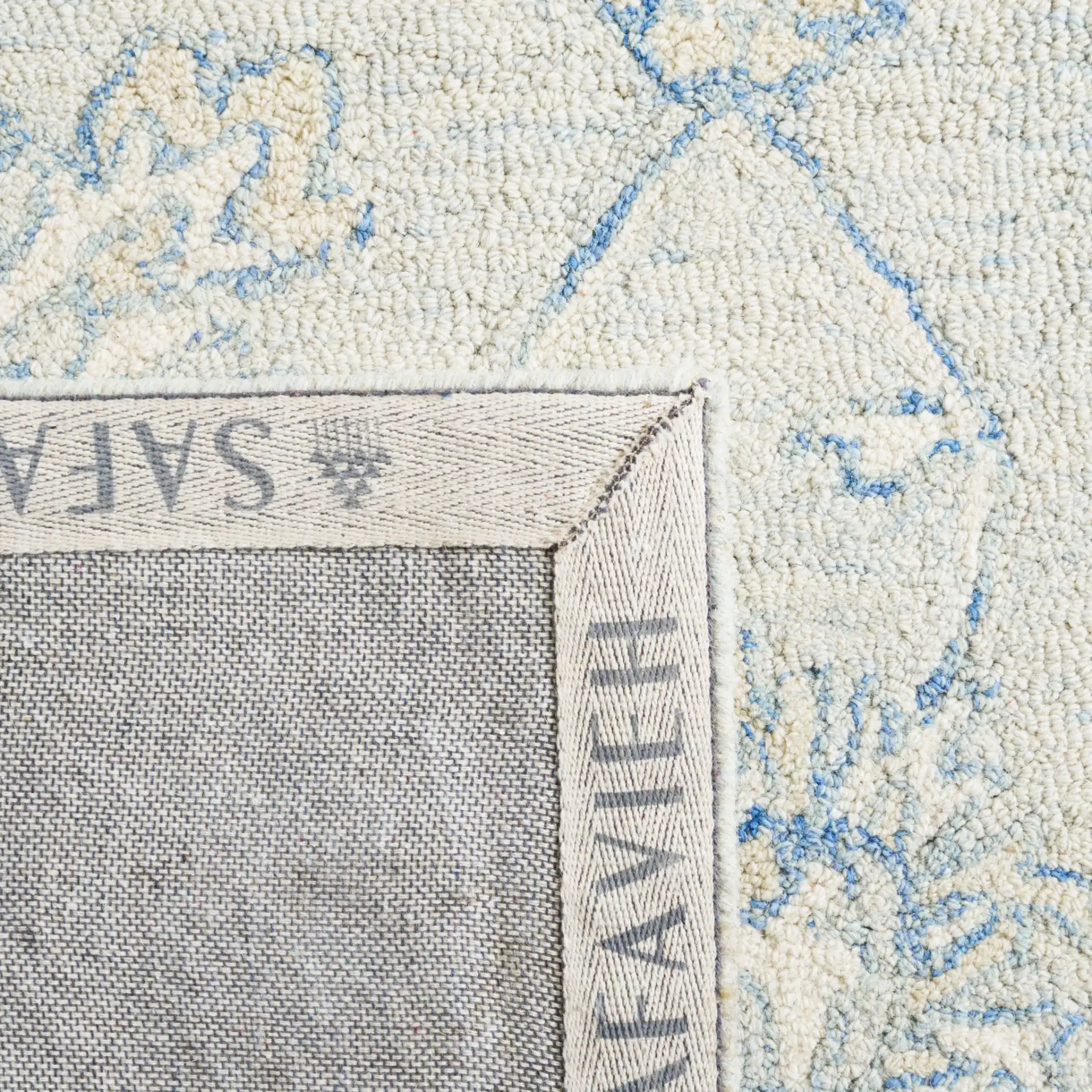 Micro-Loop Floral Border Hand-Tufted Wool Rug in Blue / Beige in a styled room