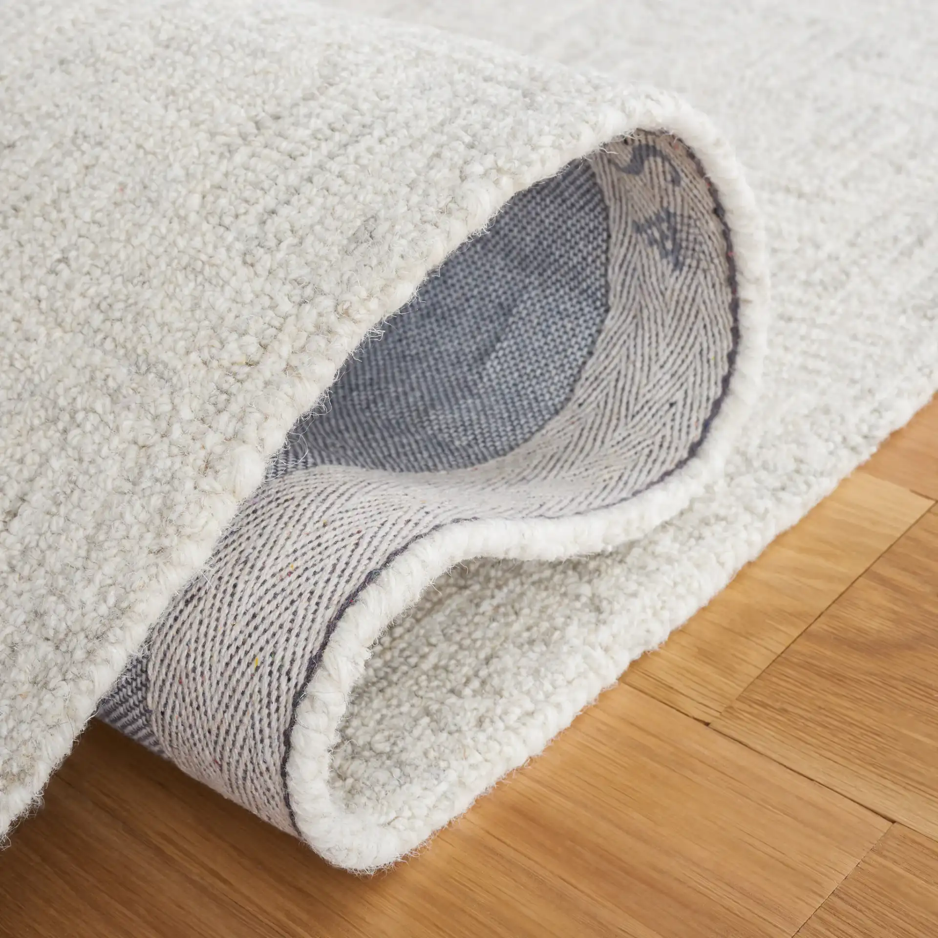 Micro-Loop Basketweave Hand-Tufted Wool Rug in Light Gray / Ivory in a styled room