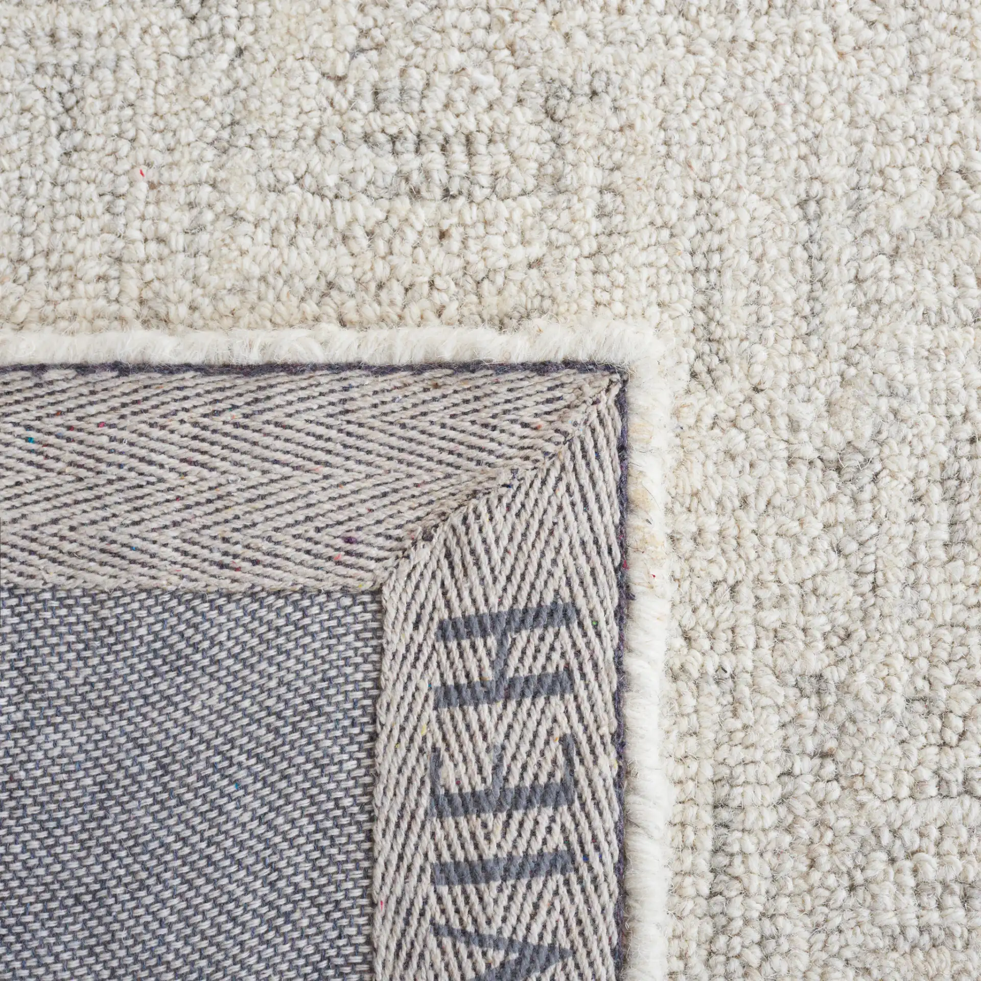 Micro-Loop Basketweave Hand-Tufted Wool Rug in Light Gray / Ivory in a styled room