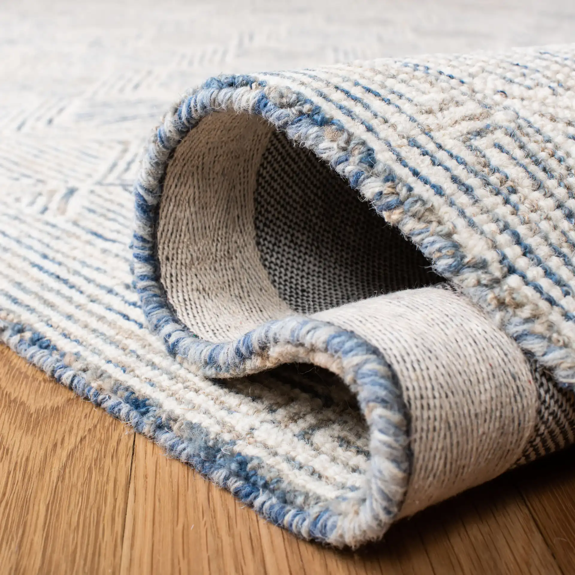 Micro-Loop Diamond Maze Hand-Tufted Wool Rug in Blue / Ivory in a styled room