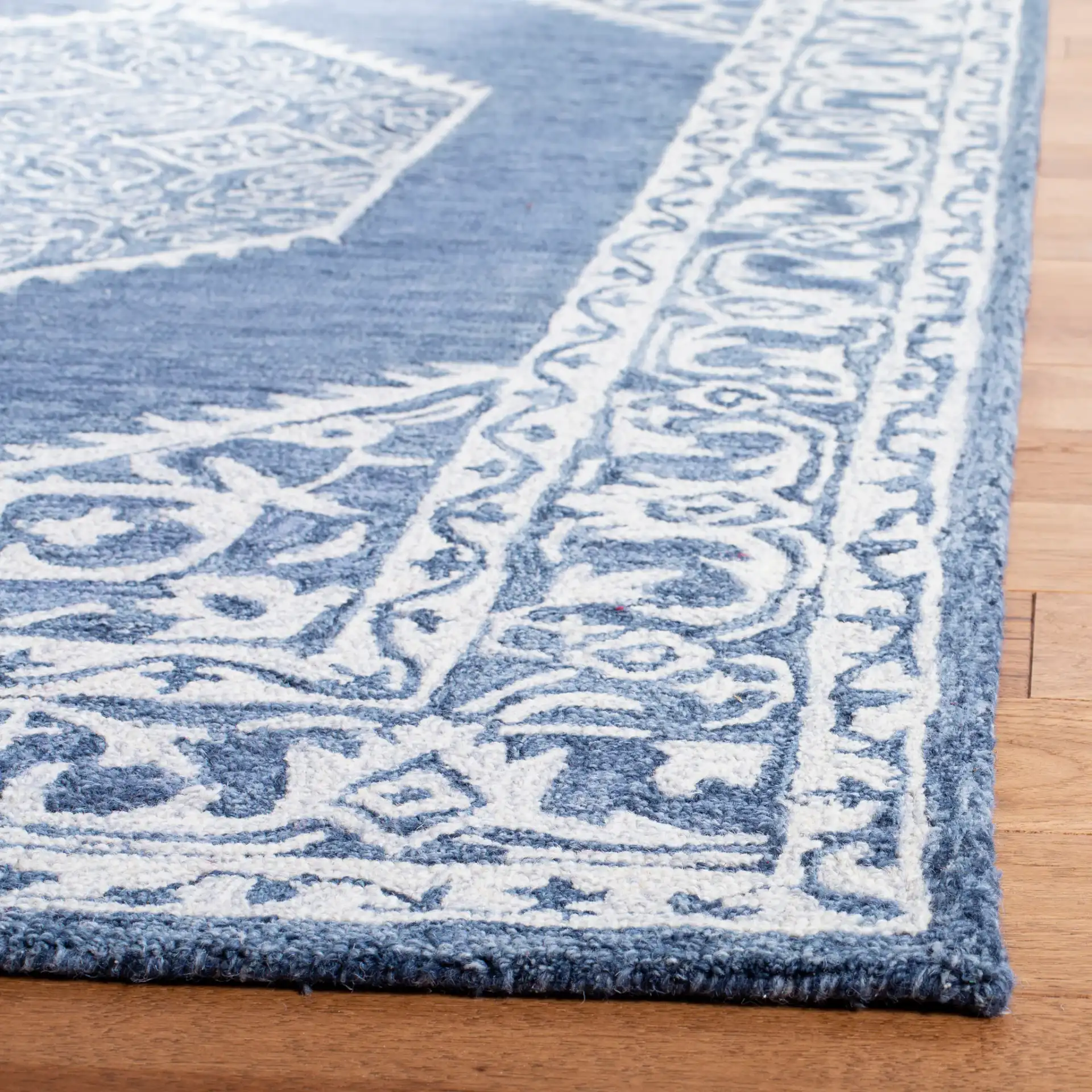 Micro-Loop Diamond Medallion Border Hand-Tufted Wool Rug in Blue / Ivory in a styled room