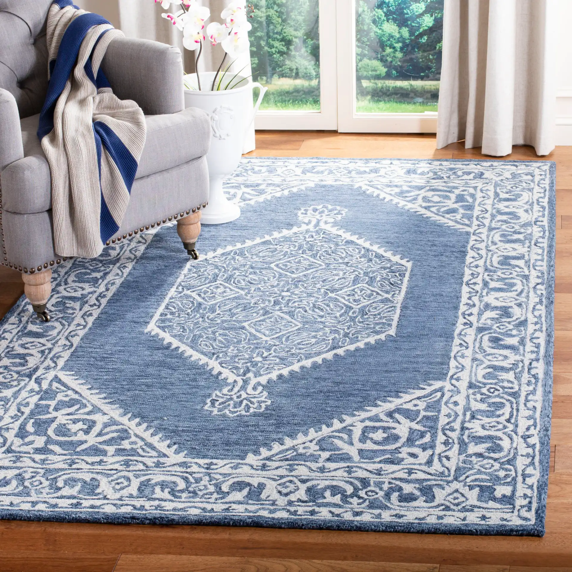 Micro-Loop Diamond Medallion Border Hand-Tufted Wool Rug in Blue / Ivory in a styled room
