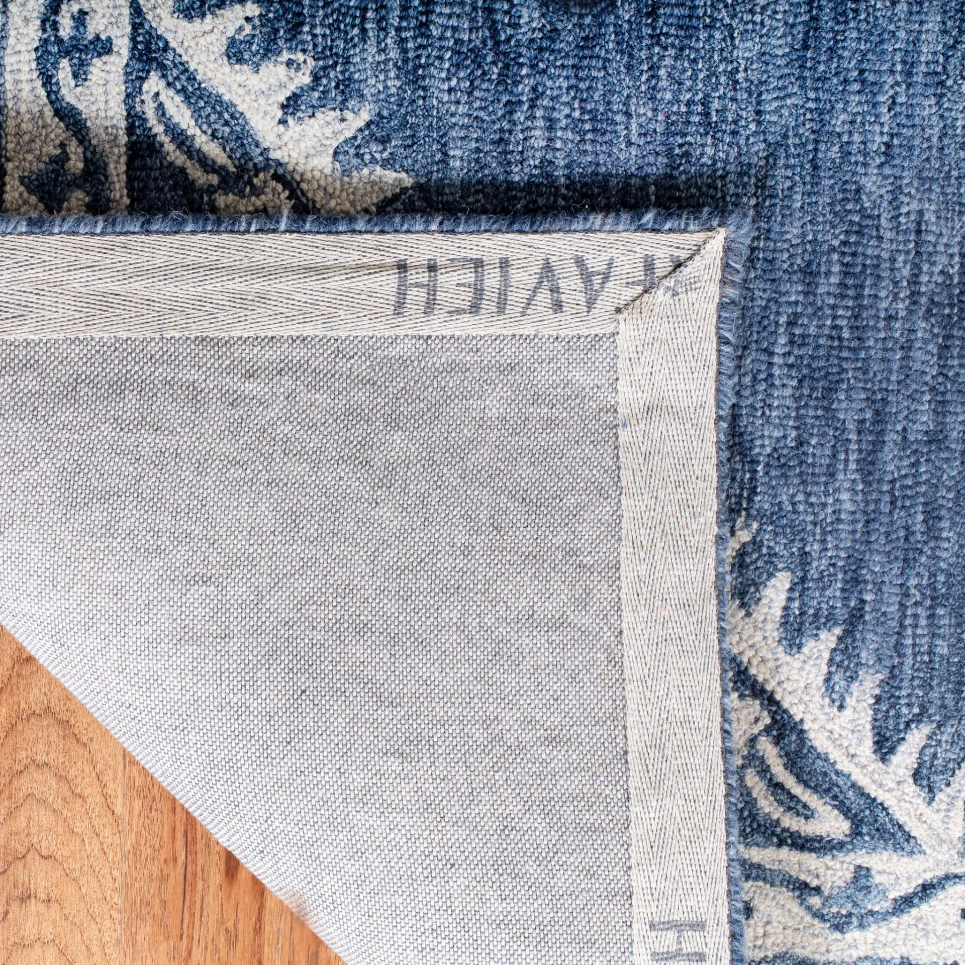 Micro-Loop Diamond Medallion Border Hand-Tufted Wool Rug in Blue / Ivory in a styled room