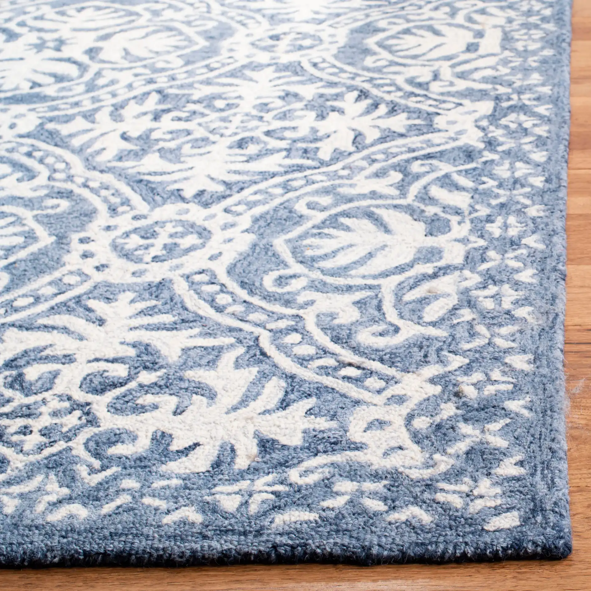 Micro-Loop Floral Tile Hand-Tufted Wool Rug in Blue / Ivory in a styled room