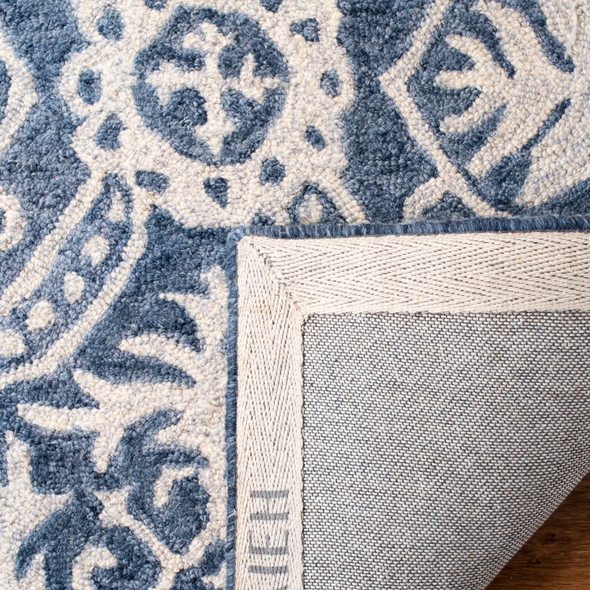 Micro-Loop Floral Tile Hand-Tufted Wool Rug in Blue / Ivory in a styled room