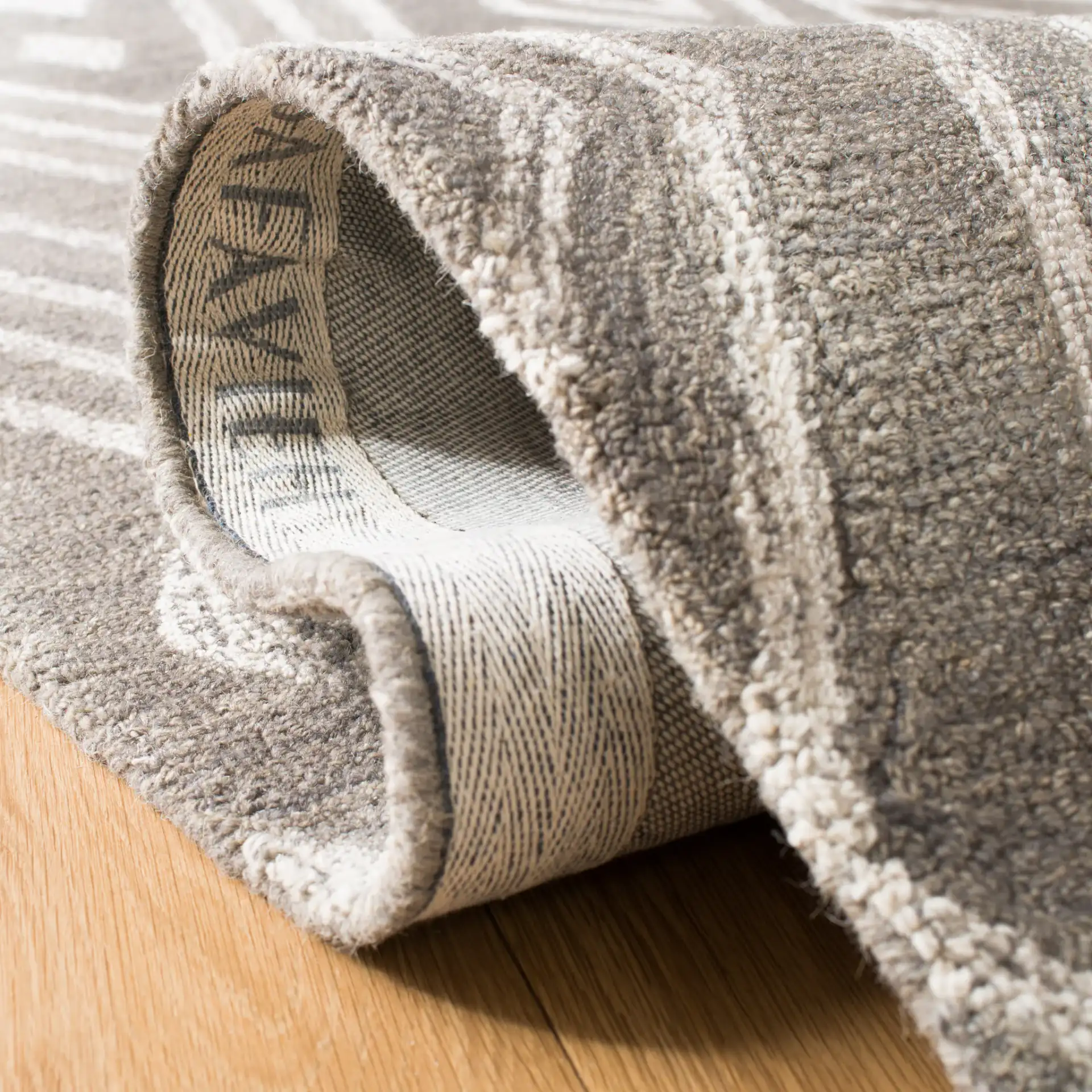 Micro-Loop Nested Diamond Hand-Tufted Wool Rug in Gray / Ivory in a styled room