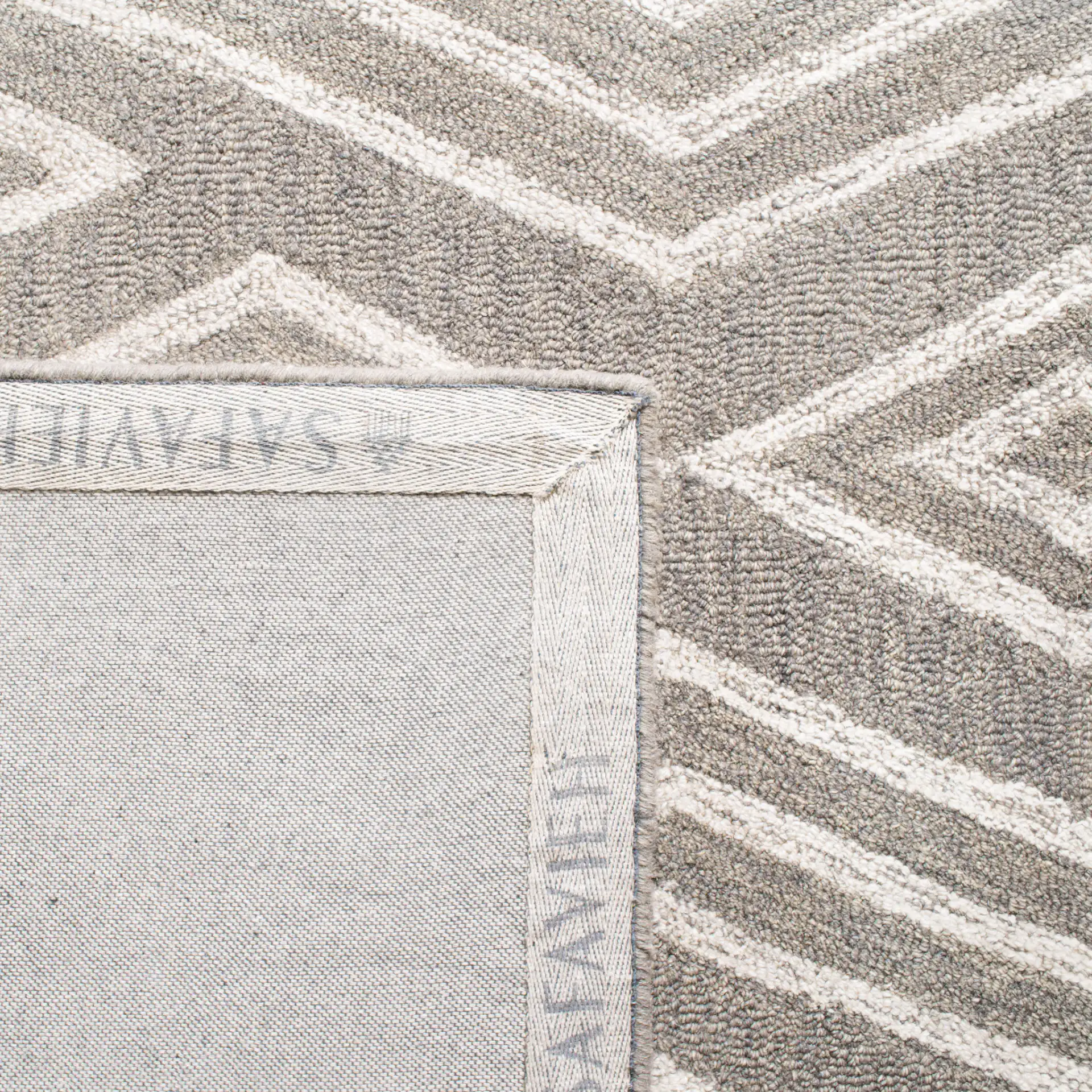 Micro-Loop Nested Diamond Hand-Tufted Wool Rug in Gray / Ivory in a styled room