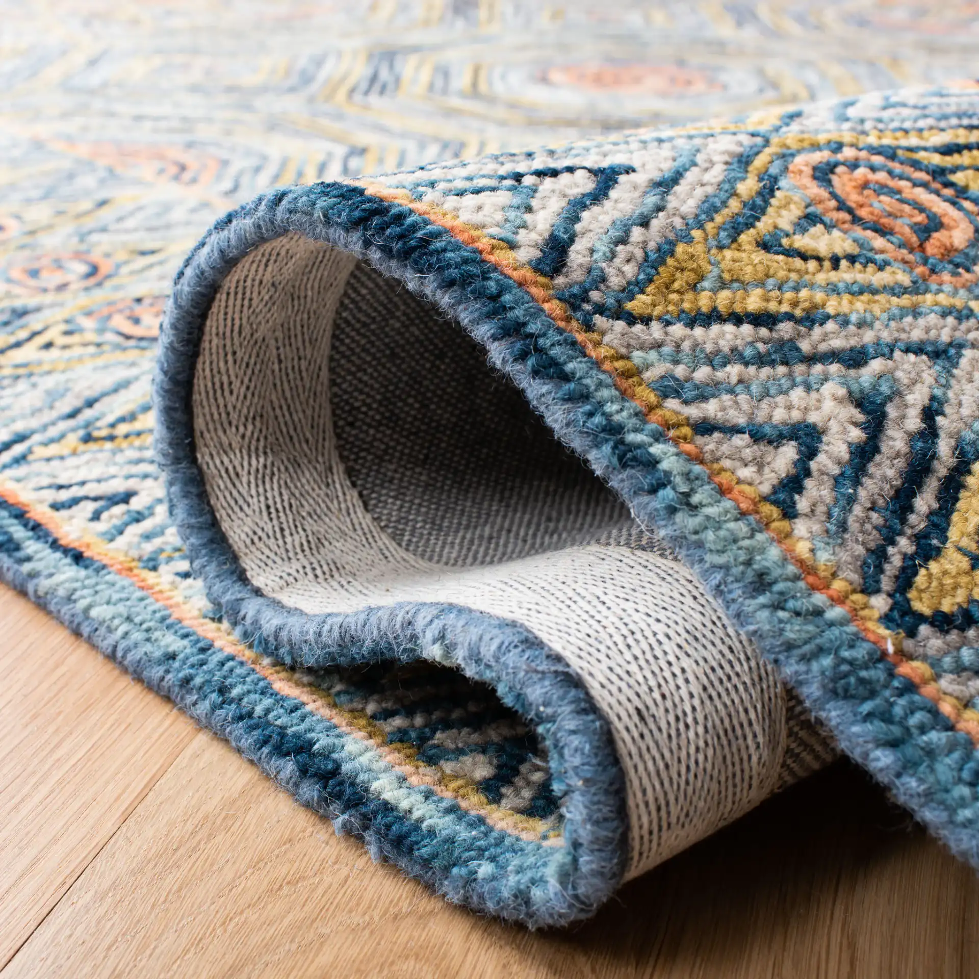 Micro-Loop Concentric Geometric Hand-Tufted Wool Rug in Green / Blue in a styled room