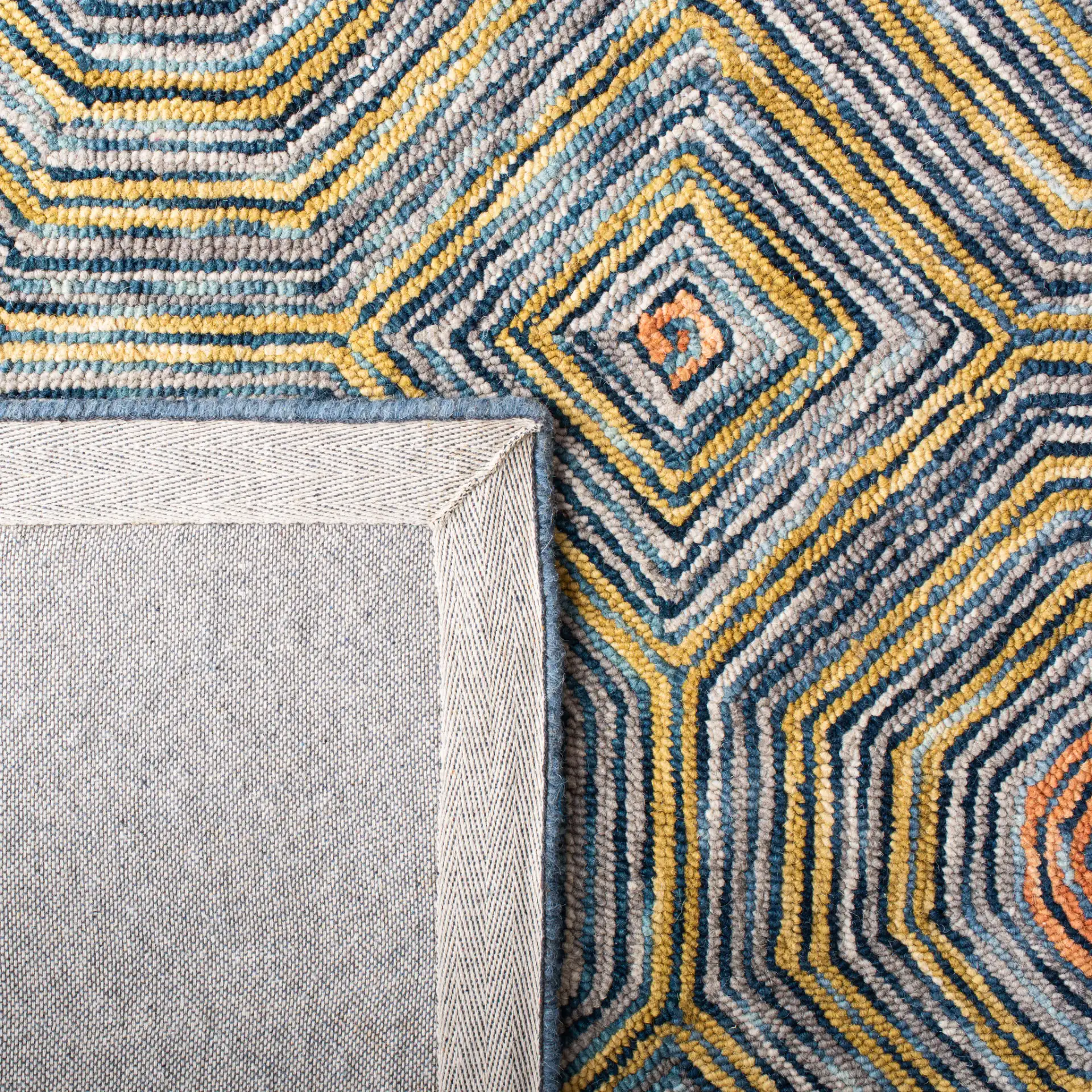 Micro-Loop Concentric Geometric Hand-Tufted Wool Rug in Green / Blue in a styled room