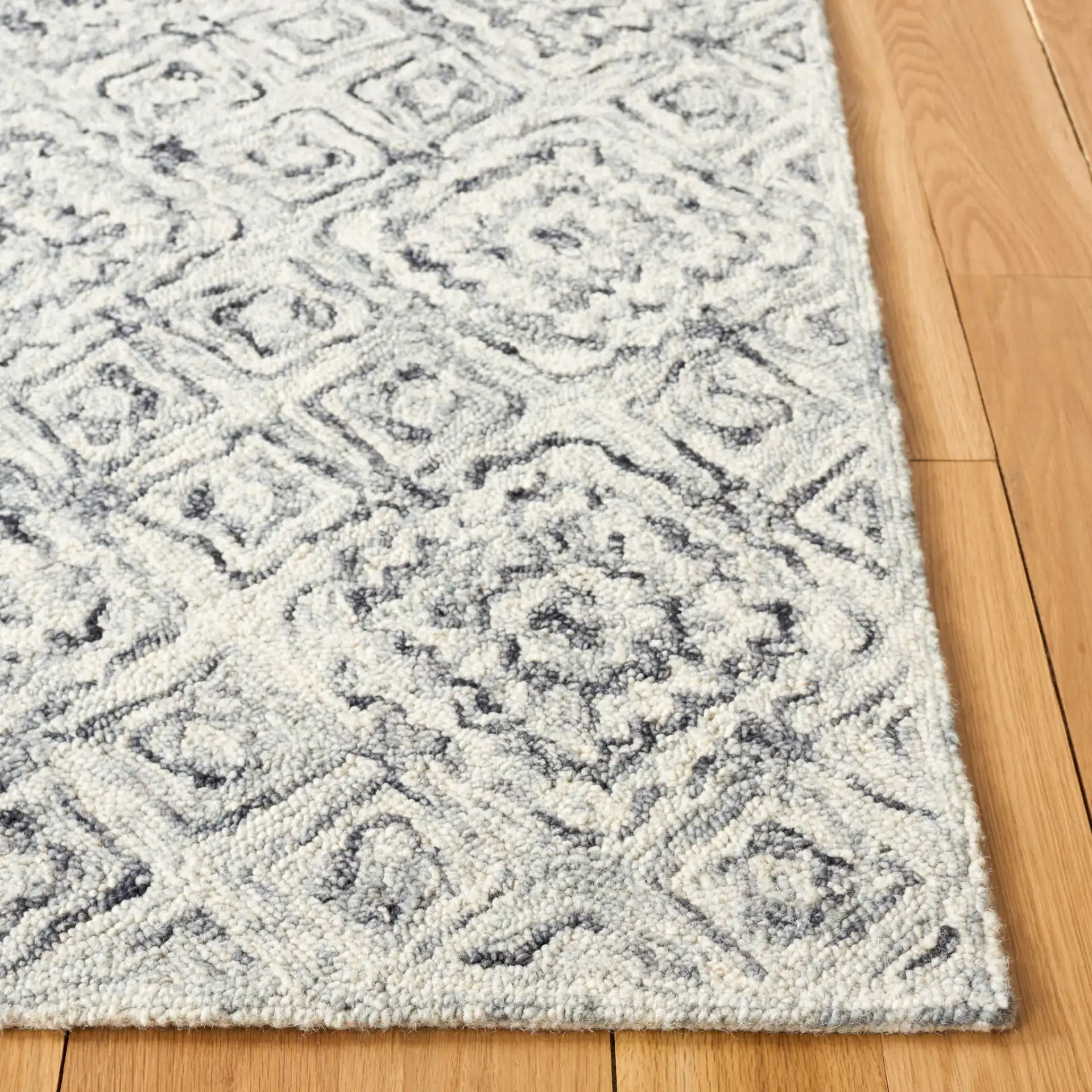 Micro-Loop Tile Lattice Hand-Tufted Wool Rug in Gray / Beige in a styled room