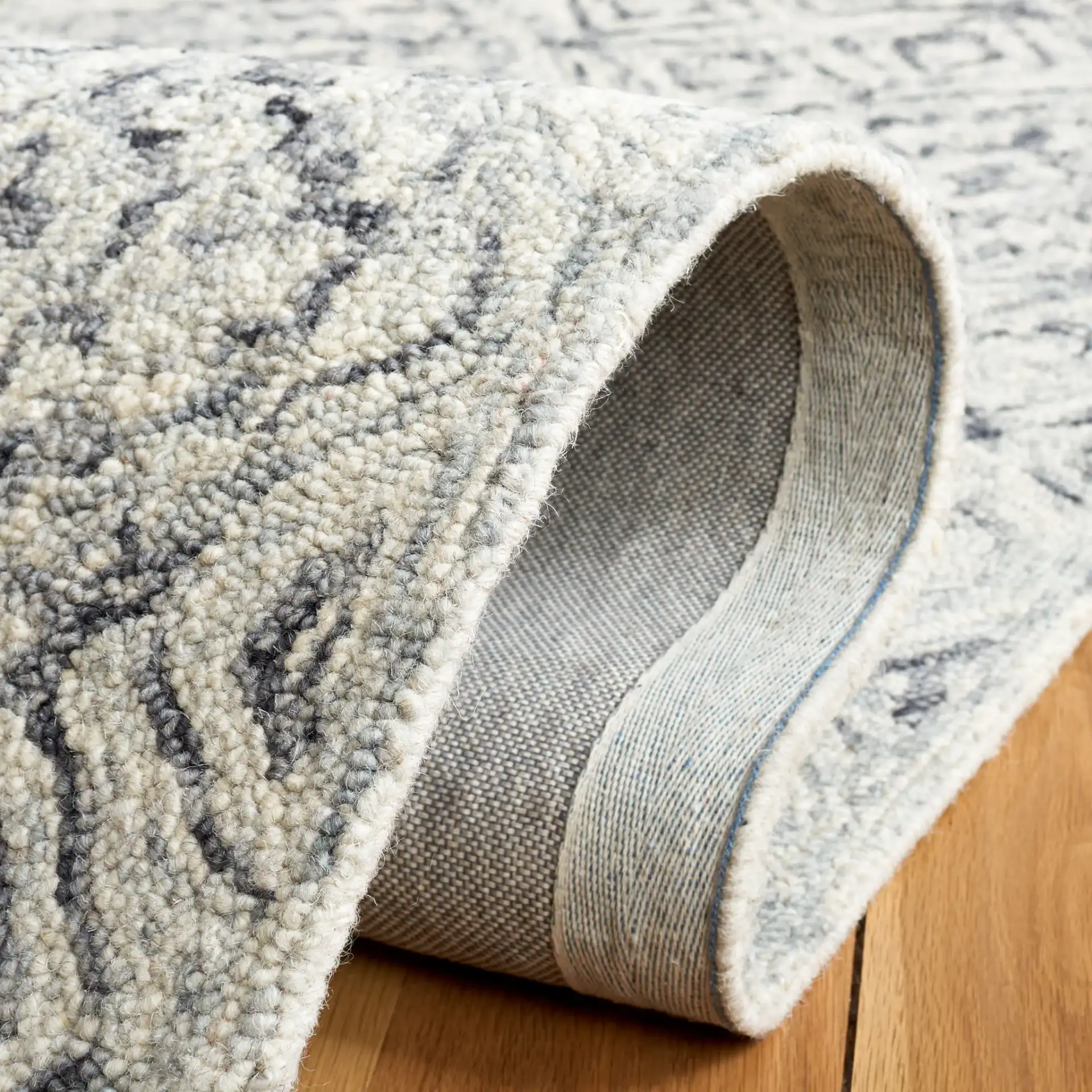Micro-Loop Tile Lattice Hand-Tufted Wool Rug in Gray / Beige in a styled room