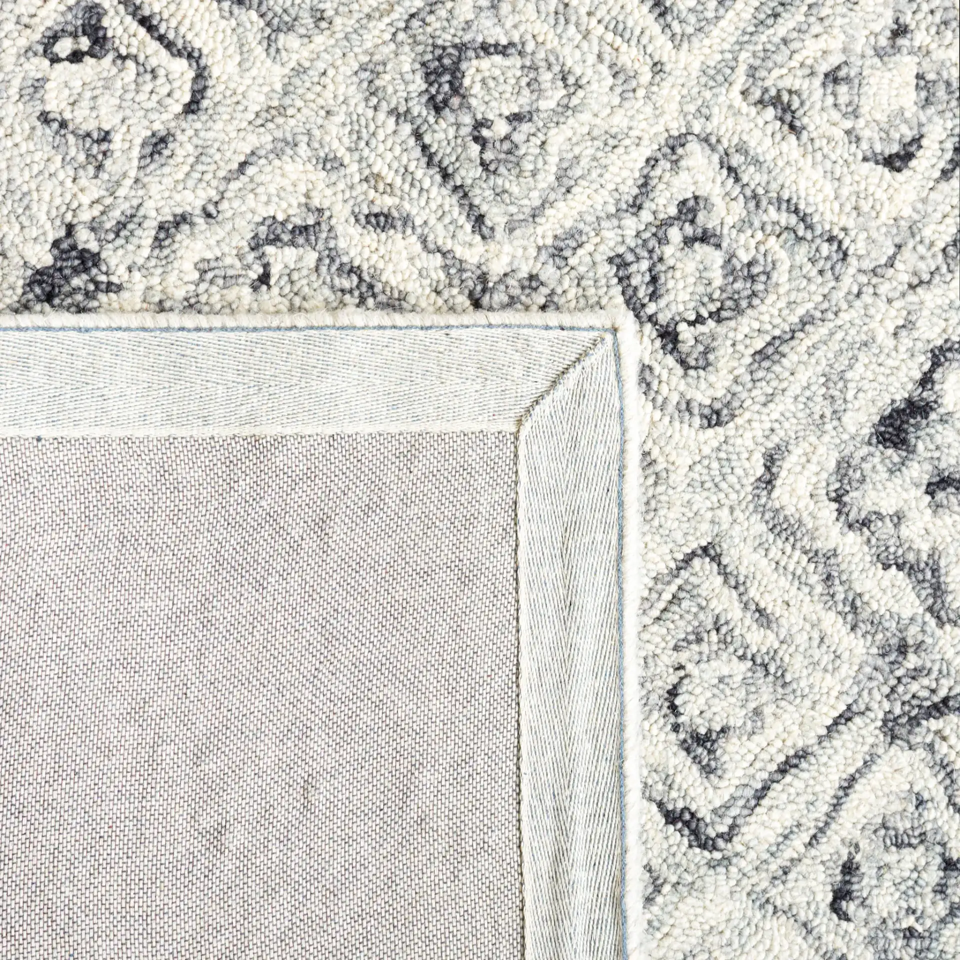 Micro-Loop Tile Lattice Hand-Tufted Wool Rug in Gray / Beige in a styled room