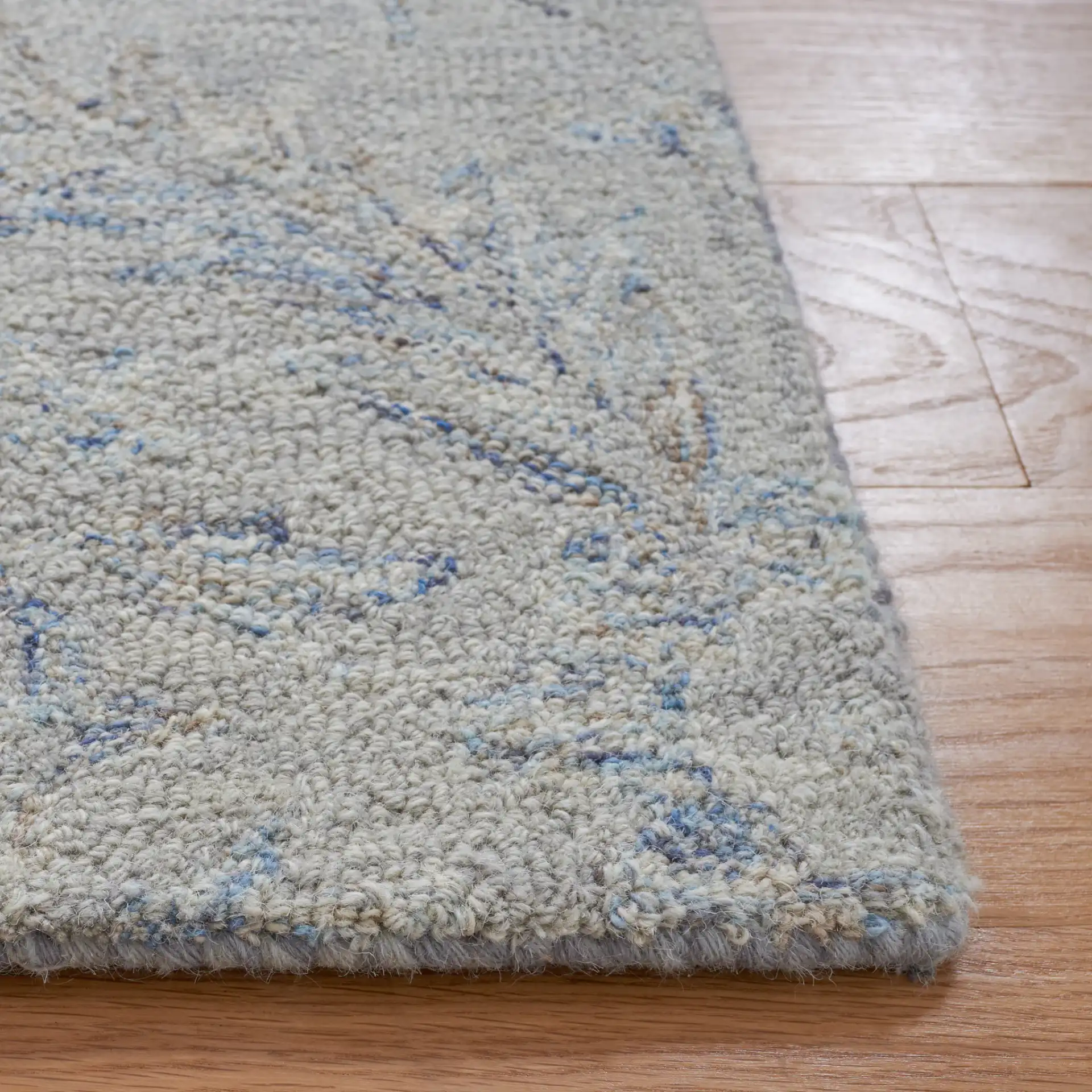 Micro-Loop Botanical Trellis Hand-Tufted Wool Rug in Gray / Blue in a styled room