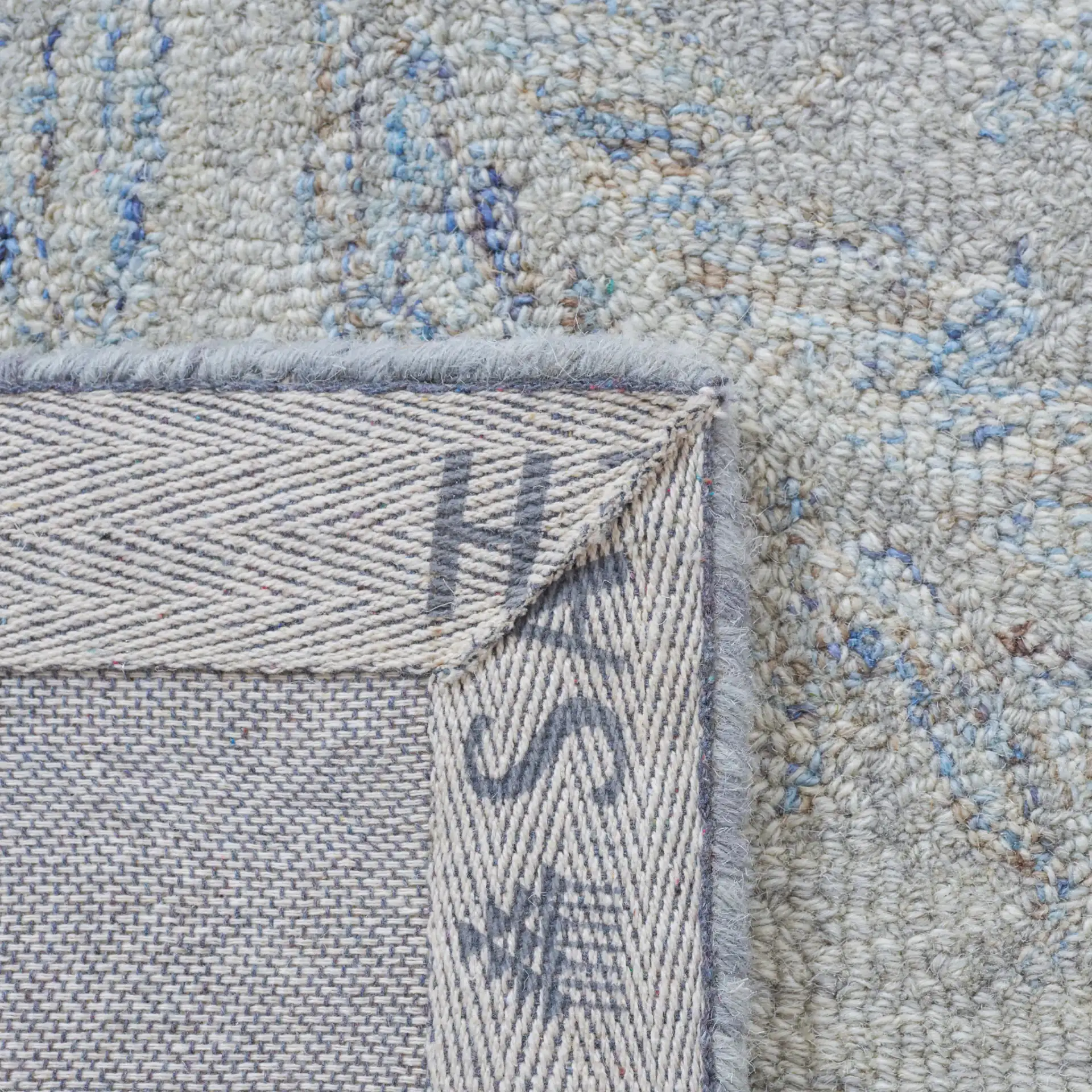 Micro-Loop Botanical Trellis Hand-Tufted Wool Rug in Gray / Blue in a styled room