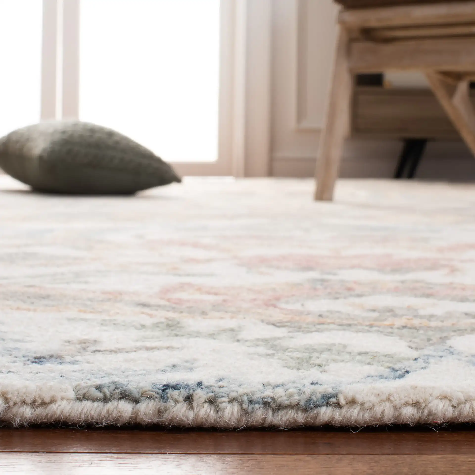 Micro-Loop Botanical Border Hand-Tufted Wool Rug in Ivory / Blue in a styled room