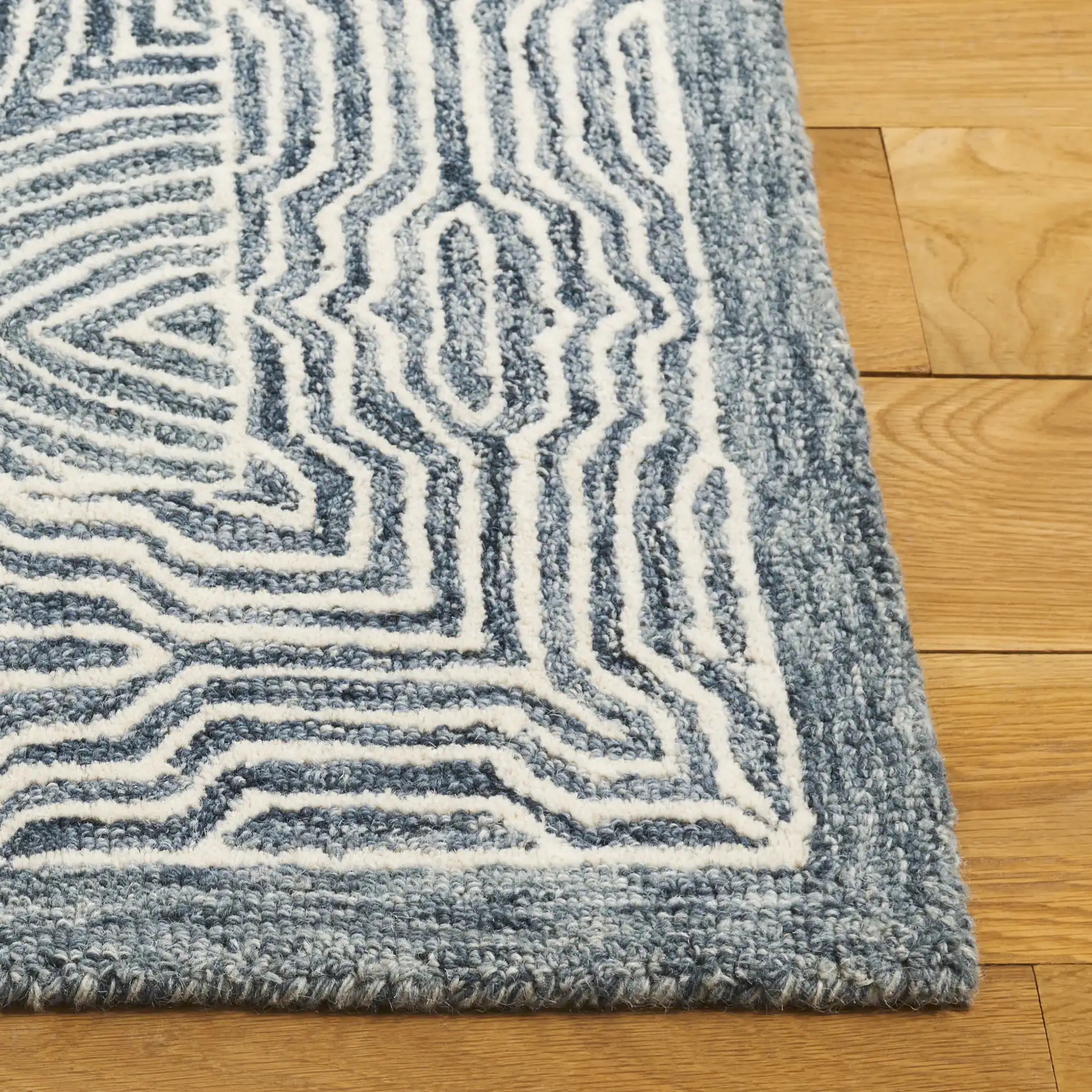 Micro-Loop Concentric Oval Hand-Tufted Wool Rug in Navy / Ivory in a styled room