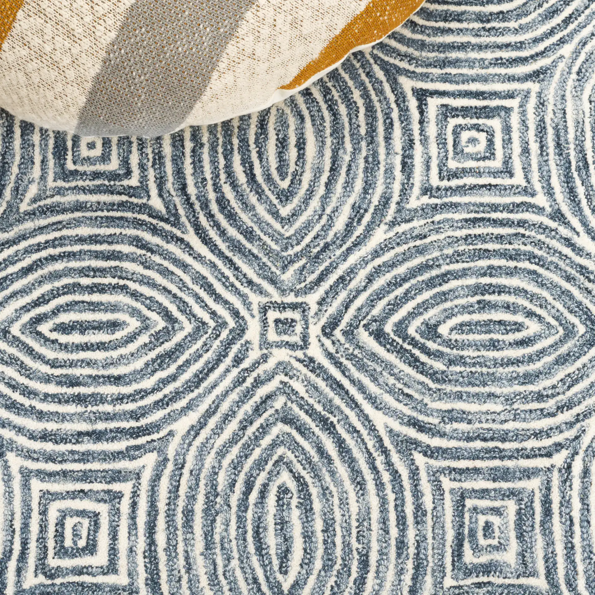 Micro-Loop Concentric Oval Hand-Tufted Wool Rug in Navy / Ivory in a styled room