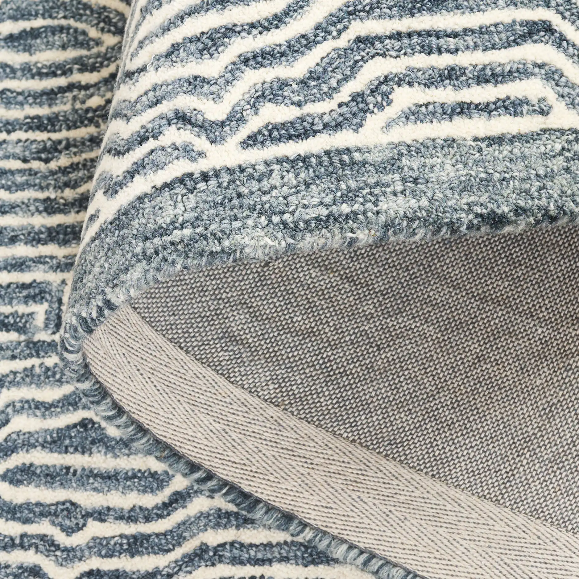 Micro-Loop Concentric Oval Hand-Tufted Wool Rug in Navy / Ivory in a styled room