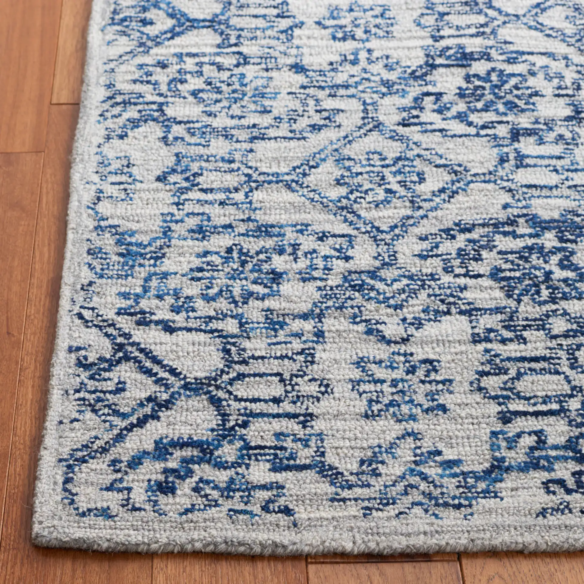 Micro-Loop Distressed Diamond Hand-Tufted Wool Rug in Blue in a styled room