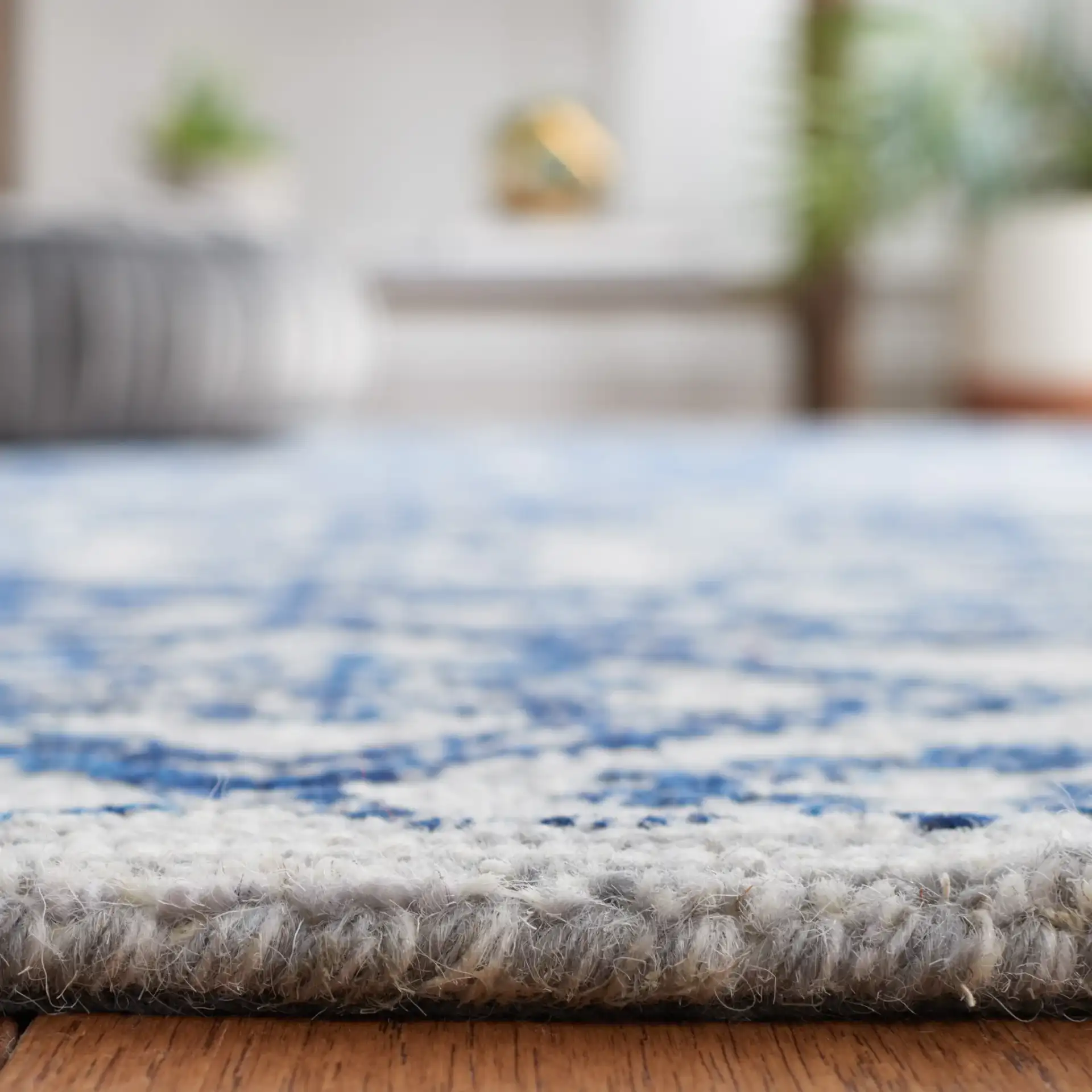 Micro-Loop Distressed Diamond Hand-Tufted Wool Rug in Blue in a styled room