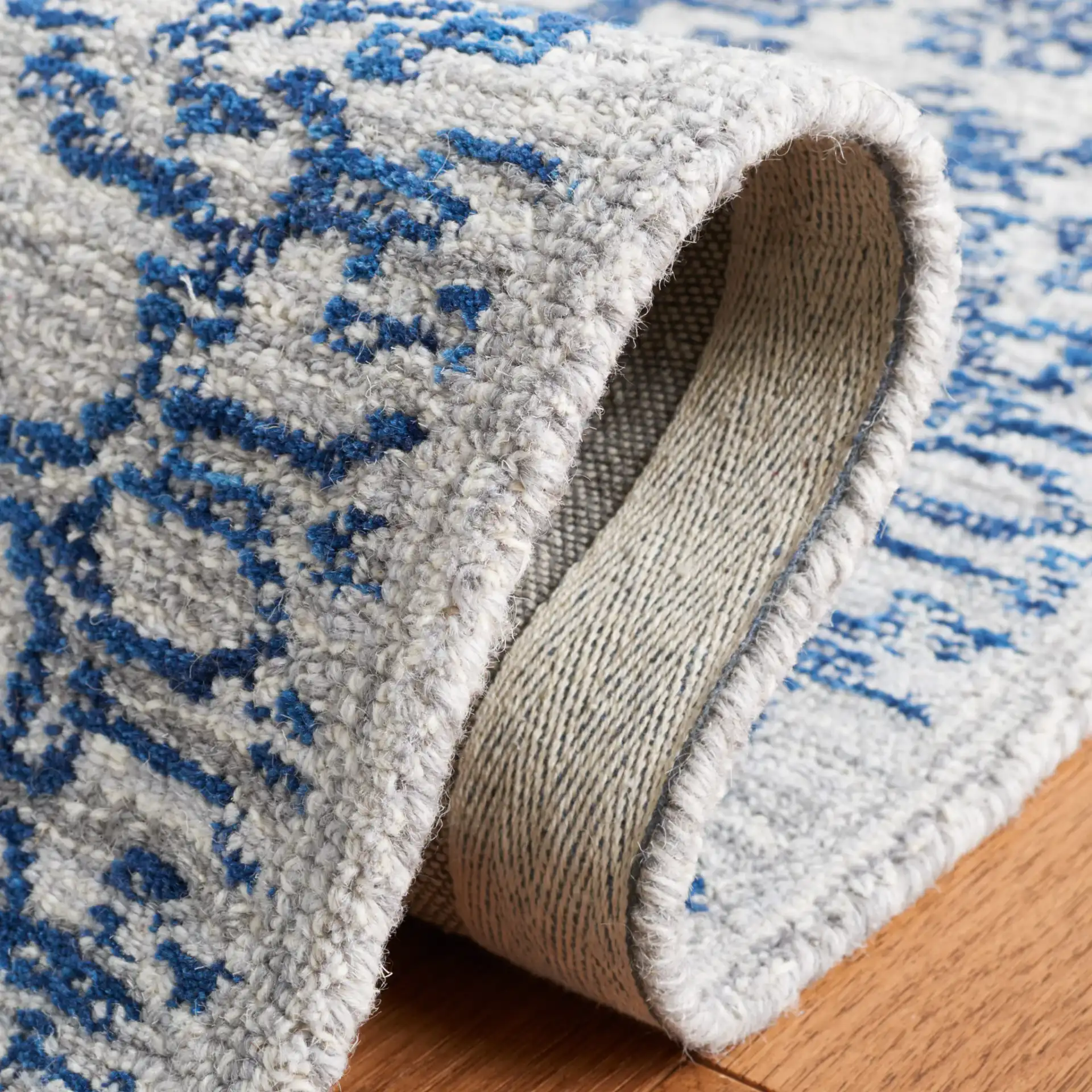 Micro-Loop Distressed Diamond Hand-Tufted Wool Rug in Blue in a styled room